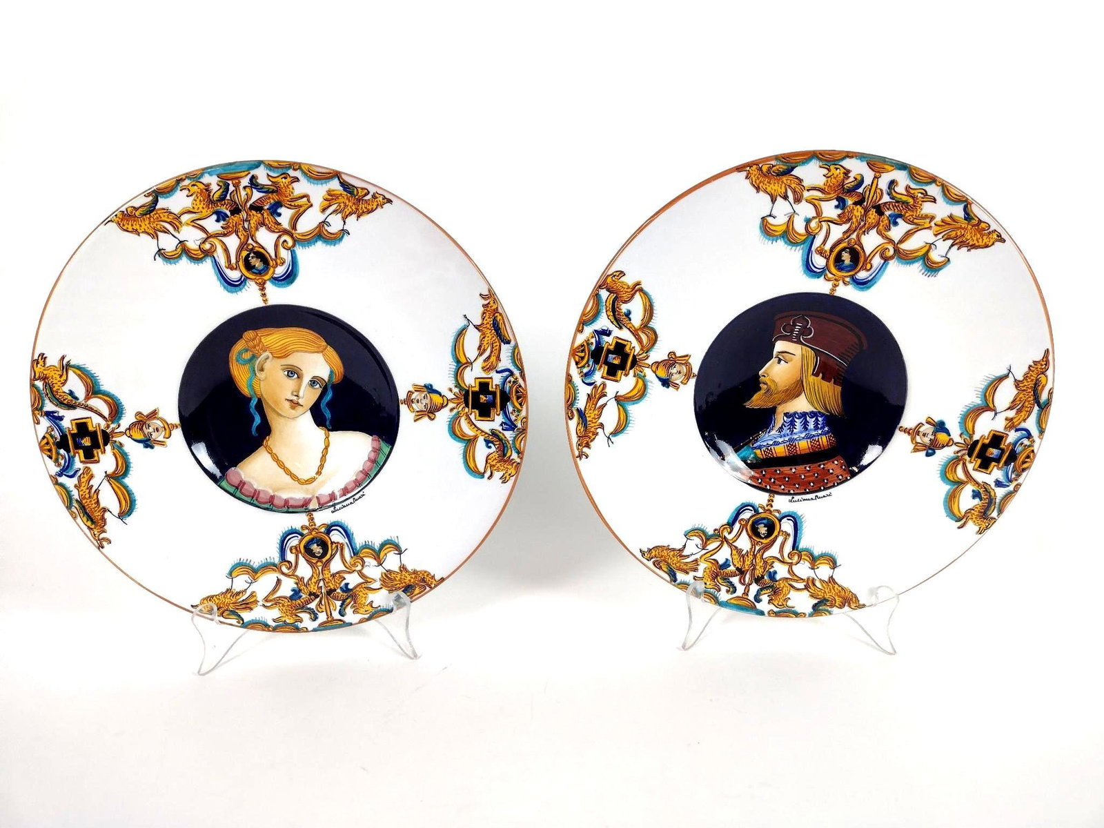 2 Deruta Portrait Cabinet Plates Signed Luciana Mari: Each 11-1/2" in diameter. EL From the estate of Robert Harman. IMPORTANT: Before bidding, please read the terms and conditions. When you registered for the auction you agreed to these terms and will b