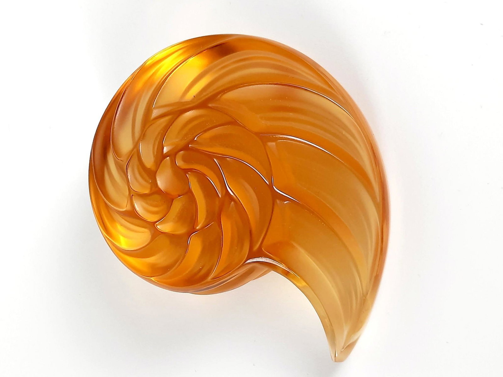 Lalique Amber Glass Nautilus Shell Figurine: 3-3/4" wide x 3" deep x 1-1/2" high. LR From the estate of Robert Harman. IMPORTANT: Before bidding, please read the terms and conditions. When you registered for the auction you agreed to these terms