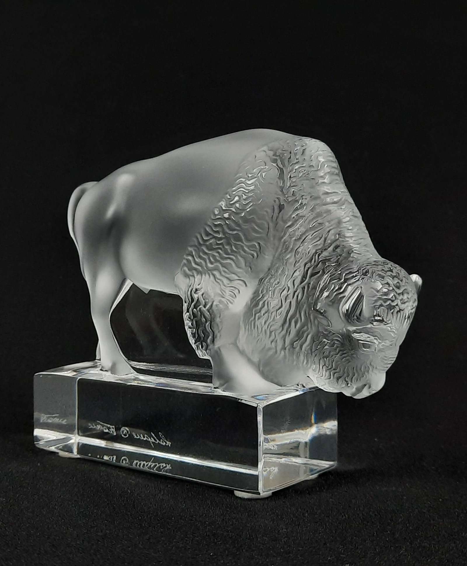 Lalique Buffalo Figurine: 5" wide x 1-3/4" deep x 4" high. LR From the estate of Robert Harman. IMPORTANT: Before bidding, please read the terms and conditions. When you registered for the auction you agreed to these terms and