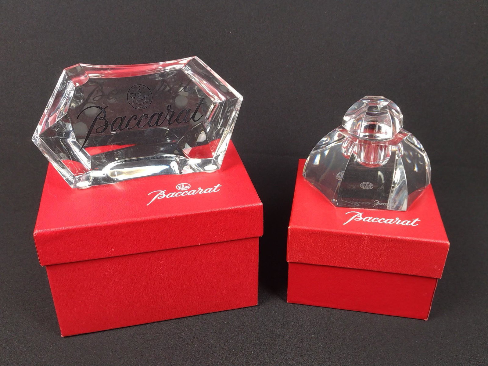 Baccarat Inkwell & Plaque: Both with original box. Plaque 5-3/4" wide X 1-1/2" deep X 3" high. Inkwell 3-3/4" wide X 3-1/4" deep X 3" high. MG. From the estate of Robert Harman. IMPORTANT: Before bidding, please read the terms 