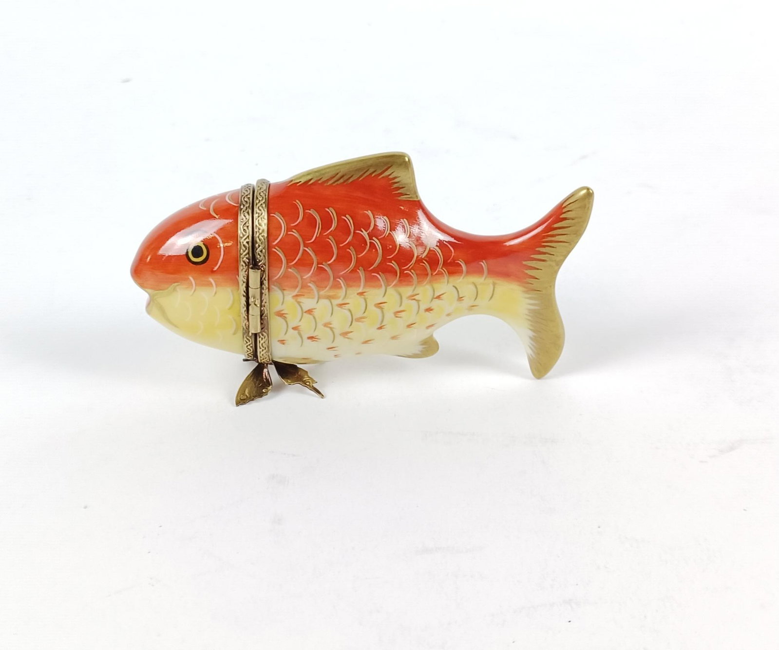 Limoges Goldfish Trinket Box: Made of porcelain. 4" long. MEG From the estate of Robert Harman. IMPORTANT: Before bidding, please read the terms and conditions. When you registered for the auction you agreed to these terms and wil
