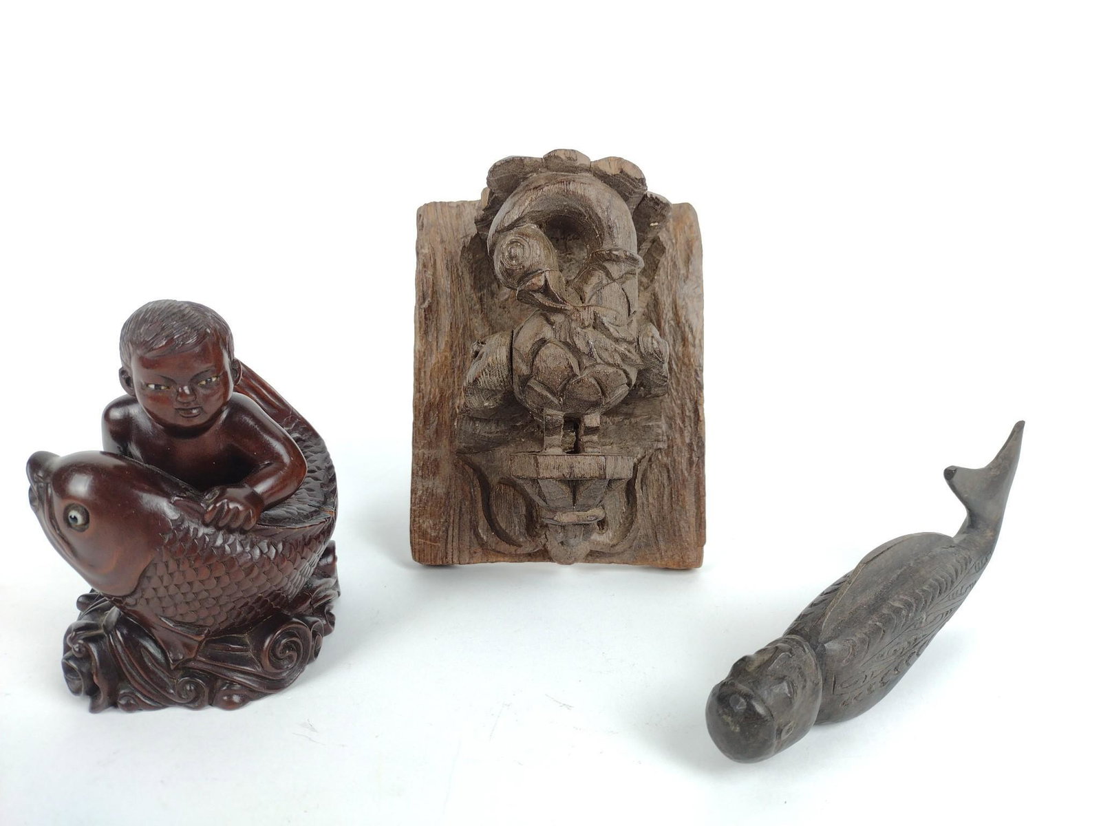 3 Wood Carvings Incl Boy With Fish: 1" to 4-1/2" wide X 2-1/2" to 5-1/2" high. MG. From the estate of Robert Harman. IMPORTANT: Before bidding, please read the terms and conditions. When you registered for the auction you agreed to thes