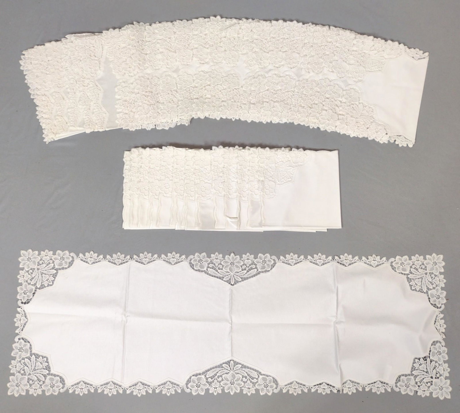 35 Flower & Heart Table Linens: Small 19" wide X 18-1/2" long. Large 15-3/4" wide X 39" long. MG. From the estate of Robert Harman. IMPORTANT: Before bidding, please read the terms and conditions. When you registered for the auction