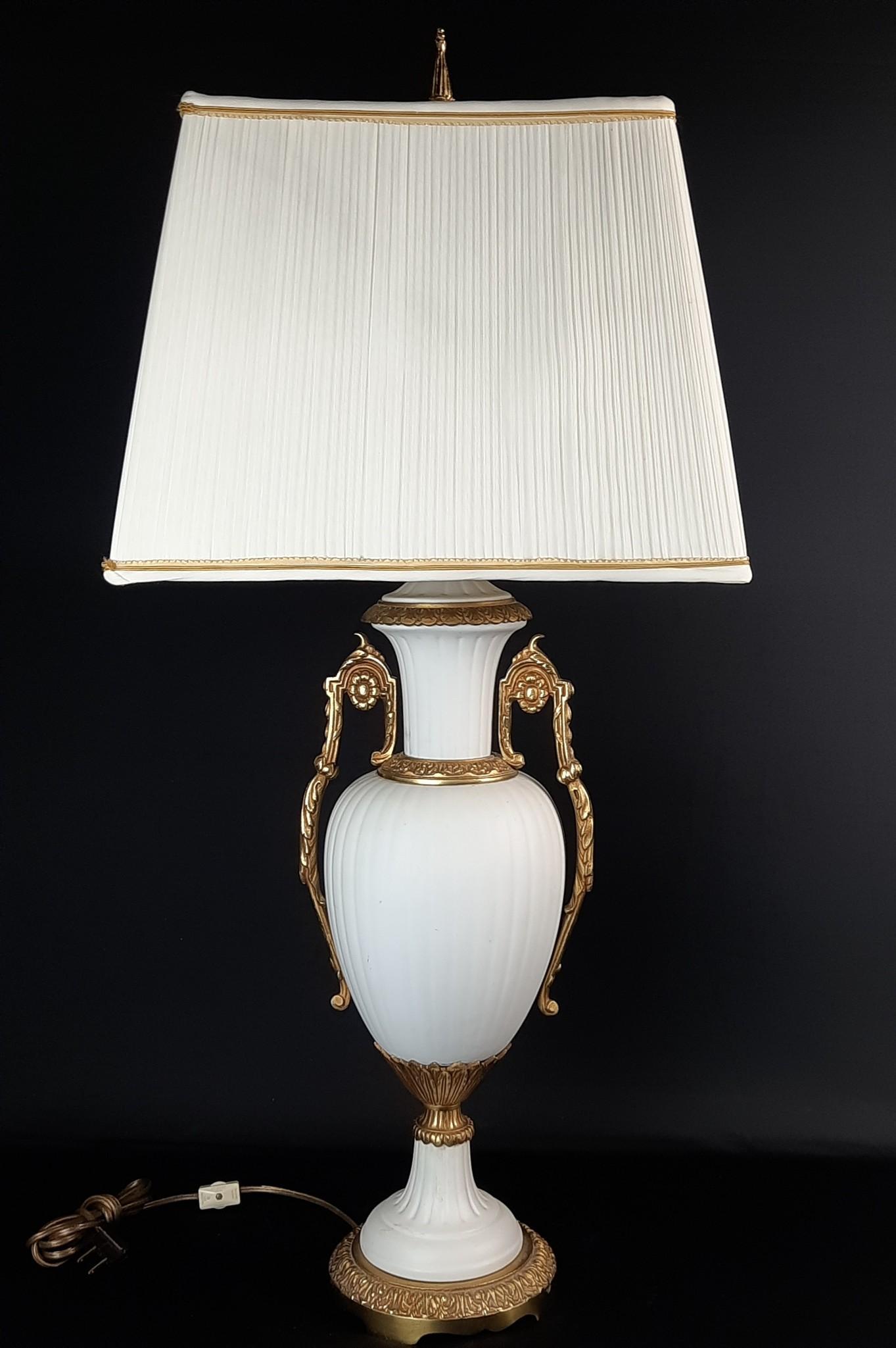 Gilt and Bisque Table Lamp: Unmarked. Working. 15-1/2" wide x 11-1/2" deep x 34-1/4" high. LR IMPORTANT: Before bidding, please read the terms and conditions. When you registered for the auction you agreed to these terms and wil
