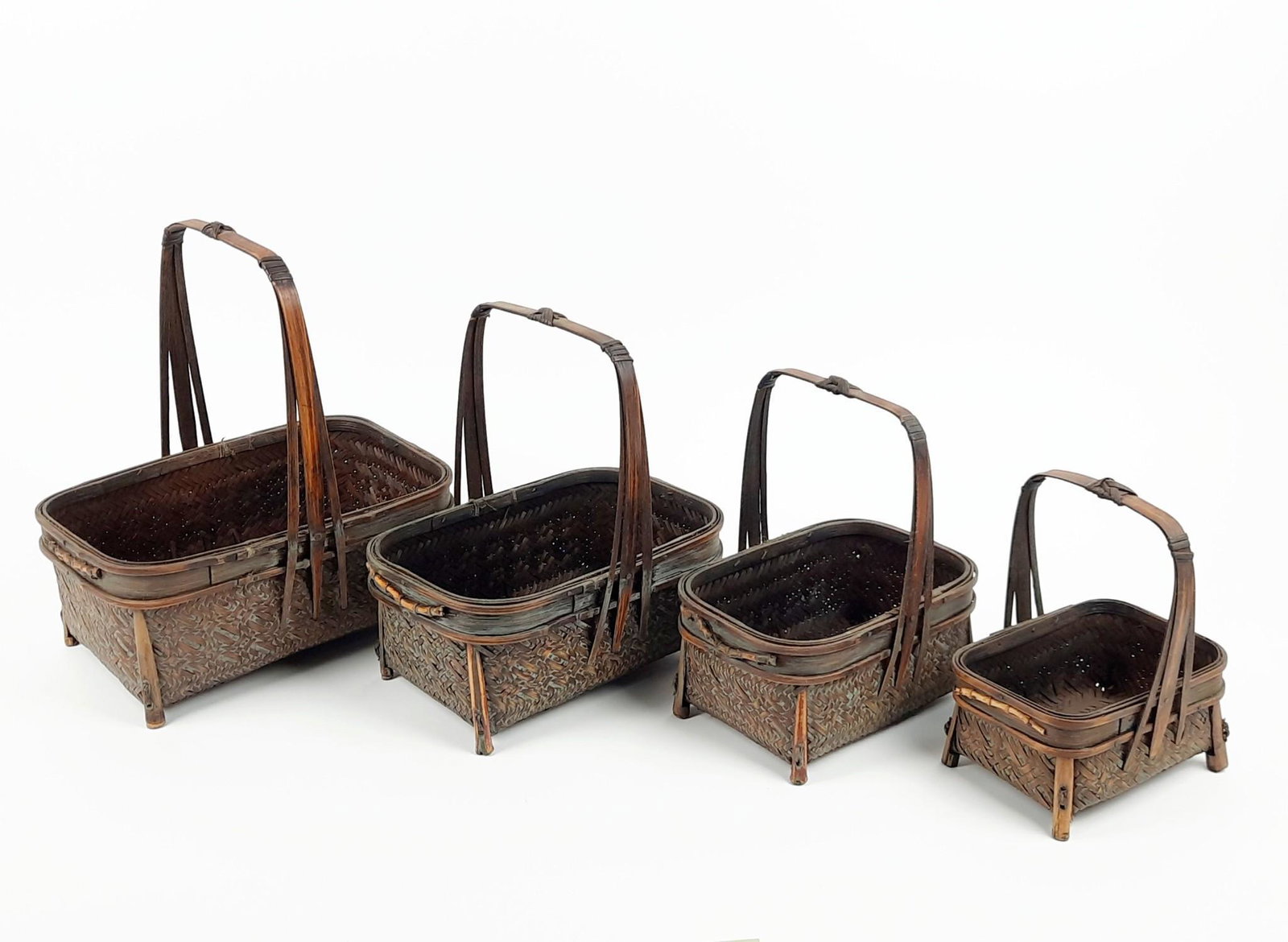 4 Nesting Ikebana Baskets: 5-1/2" to 9-3/4" wide x 4-1/4" to 7" deep x 7" to 11" high. LR IMPORTANT: Before bidding, please read the terms and conditions. When you registered for the auction you agreed to these terms and will b