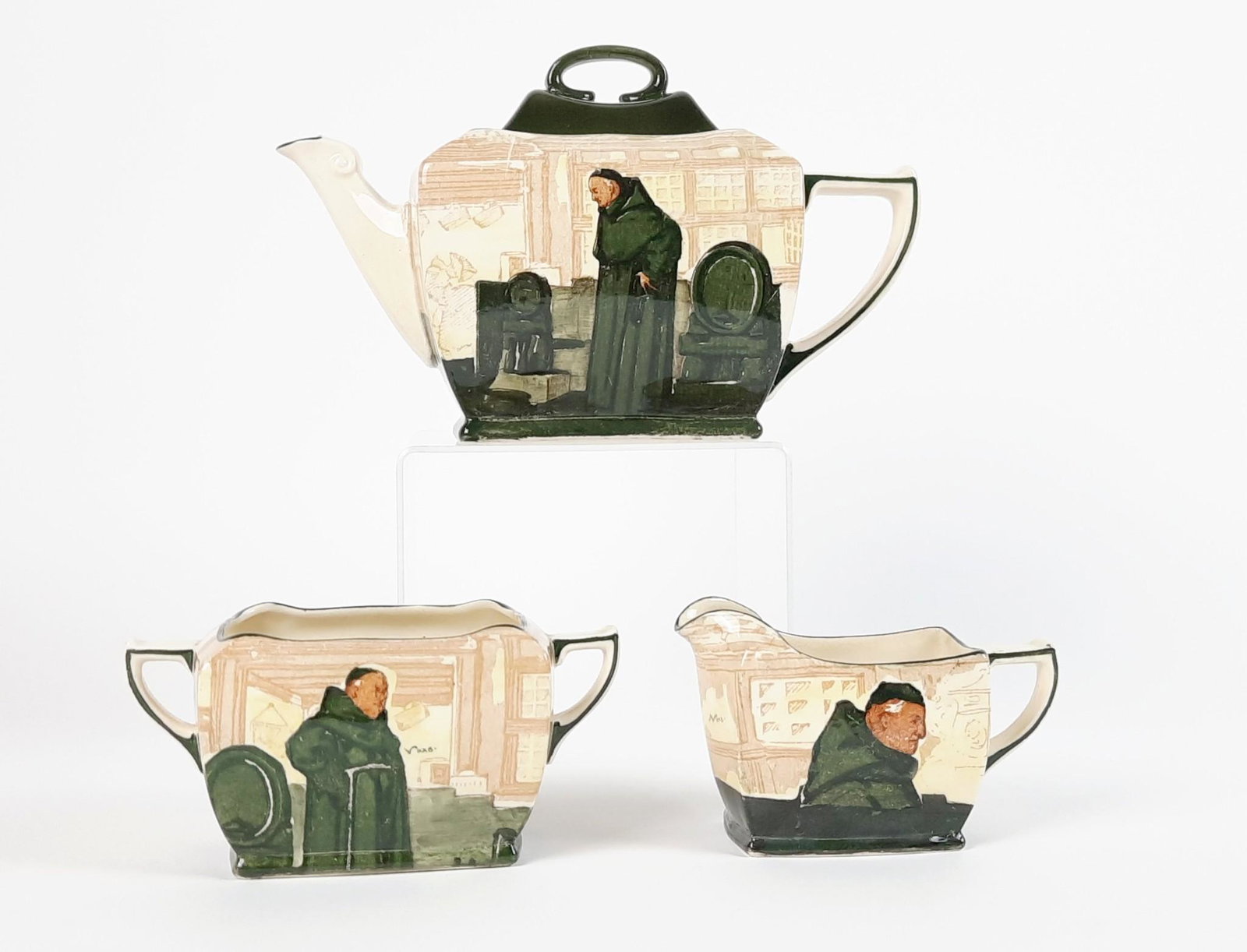 Royal Doulton Monk in the Cellar Tea Set: Includes tea pot, creamer and sugar. 5" to 9-1/4" wide x 3" to 5-1/2" high. LR IMPORTANT: Before bidding, please read the terms and conditions. When you registered for the auction you agreed to these 