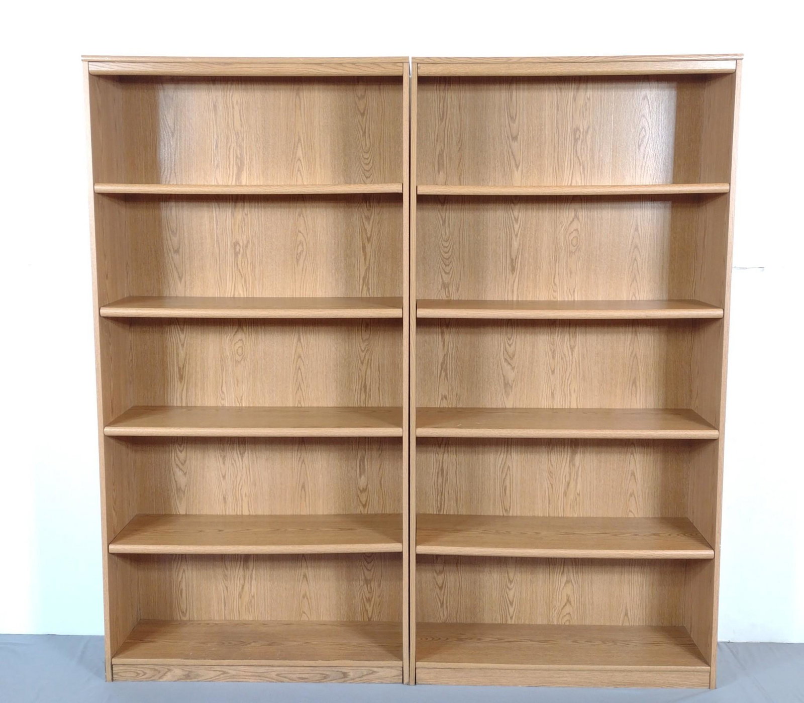 Pair Of Bush Furniture Bookcases: Each 35-1/2" wide X 11-1/2" deep X 72" high. Both have scratches. One has discoloring to bottom shelf and some water damage on left side bottom. MG. IMPORTANT: Before bidding, please read the terms an