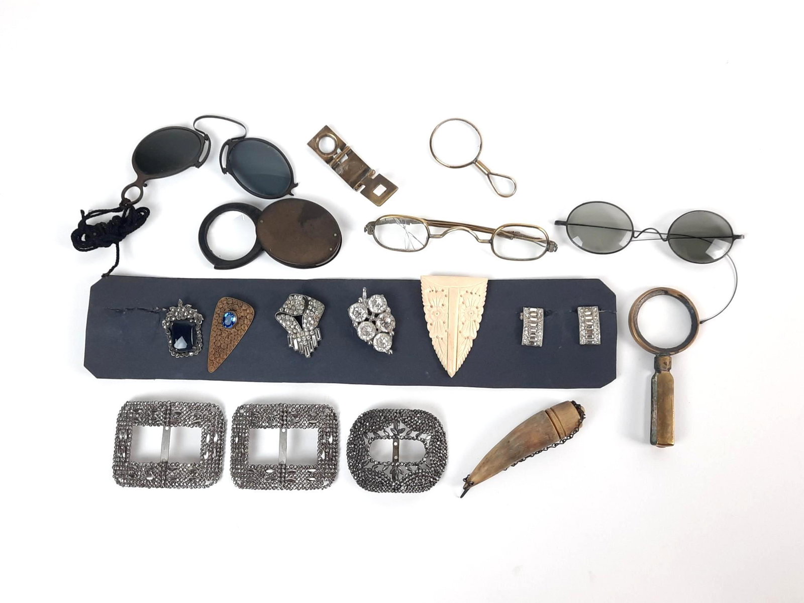 18 Pcs Shoe Buckles, Glasses and Magnifiers: Also incl bone carved box. 1" to 4" wide. One pair of glasses with broken lens. LR IMPORTANT: Before bidding, please read the terms and conditions. When you registered for the auction you agreed to th
