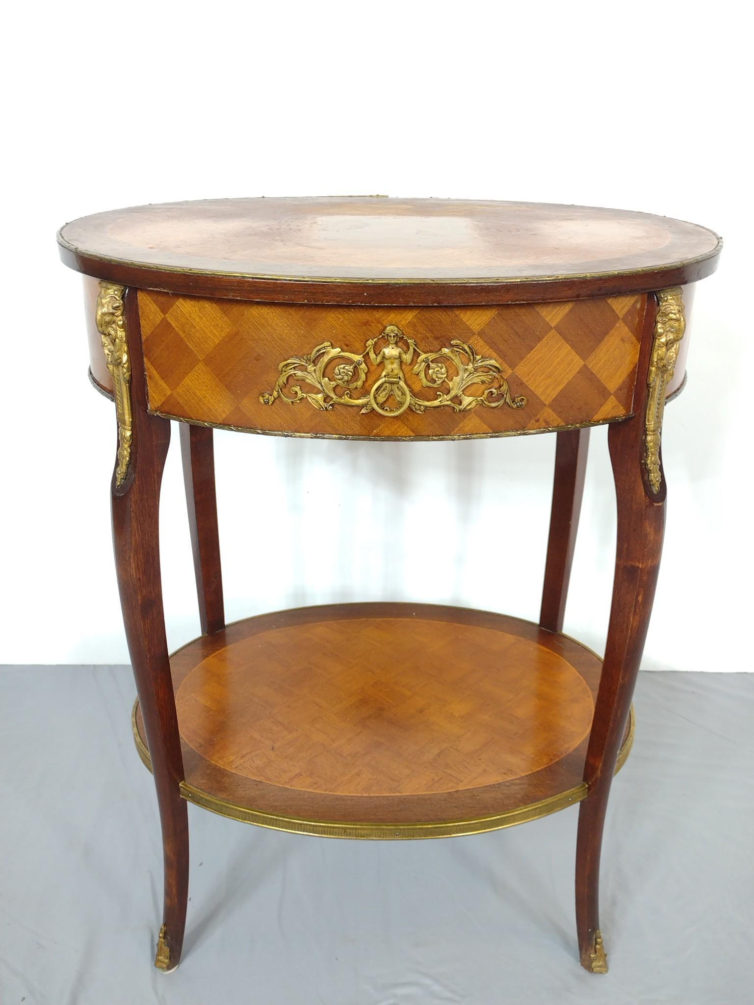 Inlaid Occasional Table With Brass Accents: 22" wide X 16-1/4" deep X 27" high. Top has finish loss. Also have a few light scratches. MG. IMPORTANT: Before bidding, please read the terms and conditions. When you registered for the auction you a