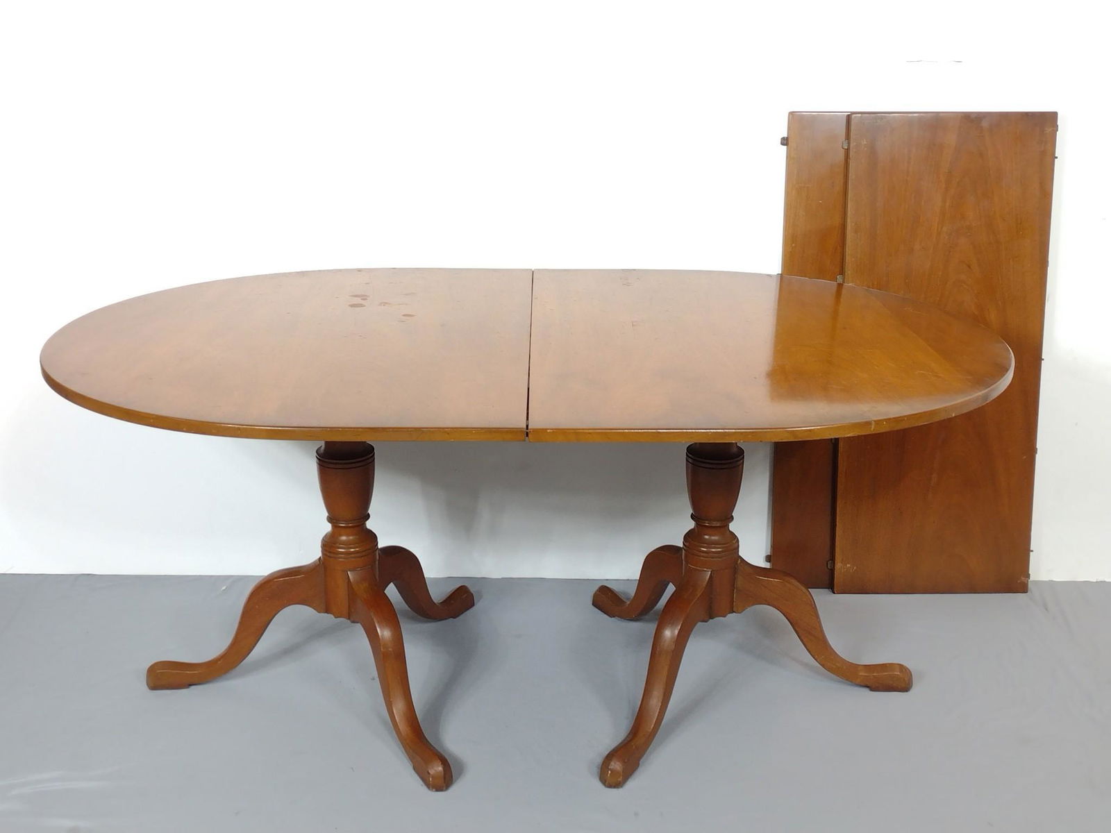 Kittinger Dining Table With Two Leaves: Pattern number GV101: Table 68-1/4" wide X 44" deep X 29-1/2" high. Table leaves 18" wide each. Table top and leaves have some scratches. MG. IMPORTANT: Before bidding, please read the terms and condi