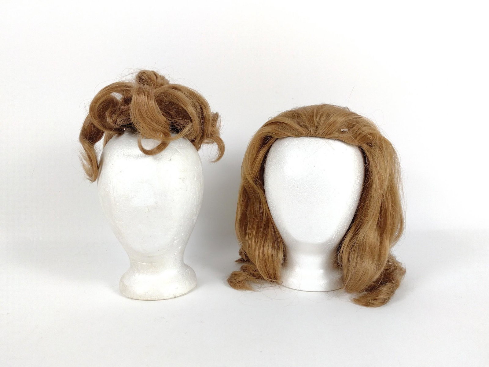 2 Human Hair Wigs: Made of Human hair. Various Sizes. both with carrying case. BC IMPORTANT: Before bidding, please read the terms and conditions. When you registered for the auction you agreed to these terms and will b