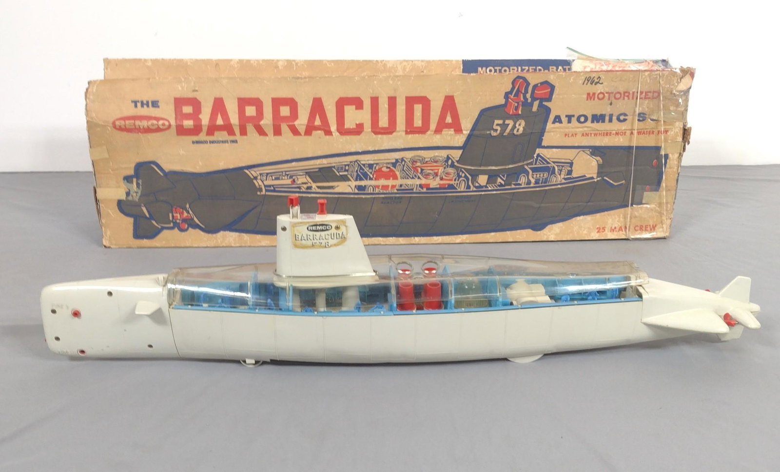 Remco The Barracuda Atomic Sub W/ Original Box: 6" wide X 38" long X 4-1/2" high. To has cracks and is bowed. Also has some discoloration. Sticker is peeling on the top. IMPORTANT: Before bidding, please read the terms and conditions. When you regi