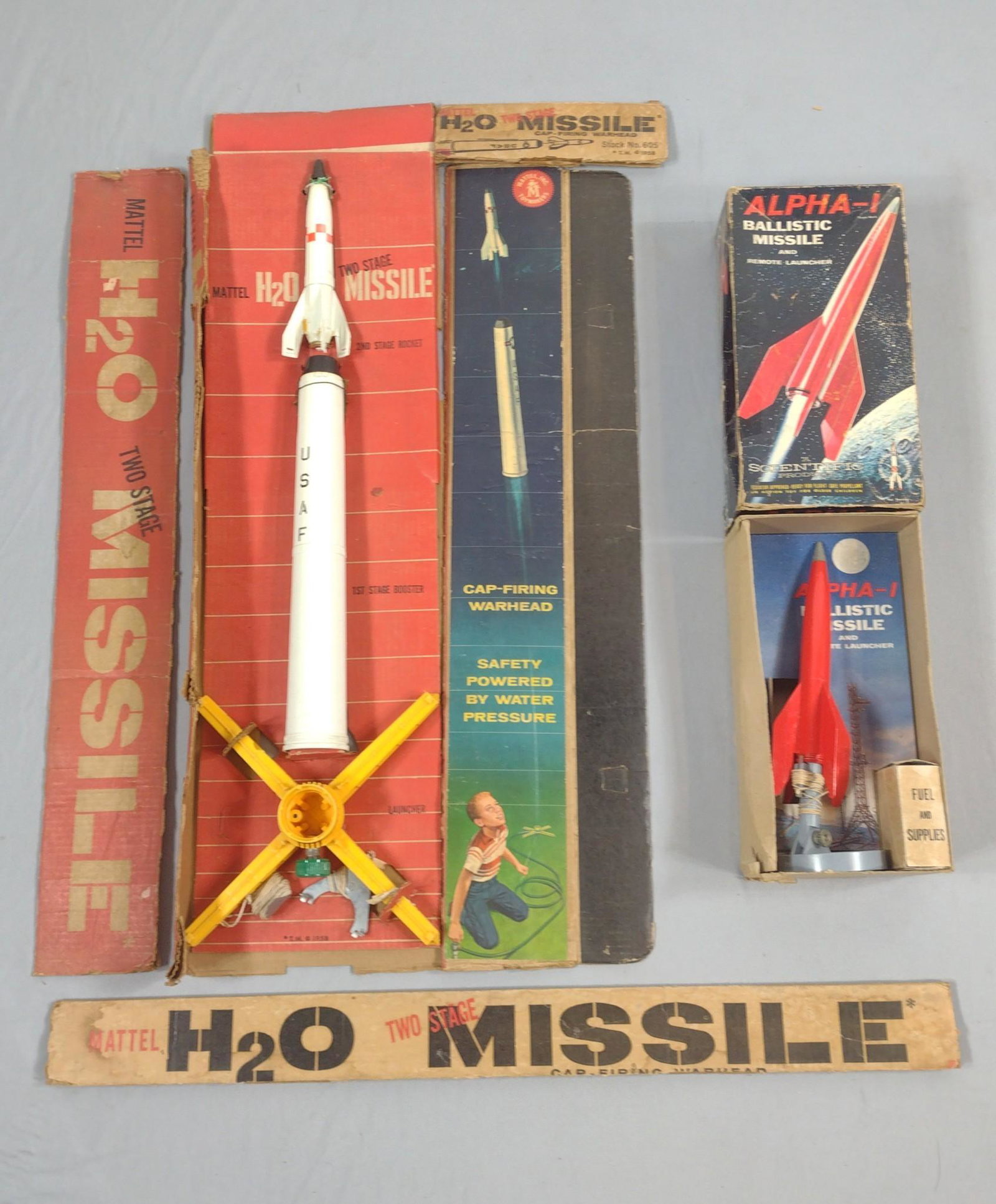 H20 and Alpha-1Toy Missile W/ Original Boxes: Mattel H20 two stage missile 24" long. Scientific product Alpha 1 ballistic missile 12" long. IMPORTANT: Before bidding, please read the terms and conditions. When you registered for the auction you a