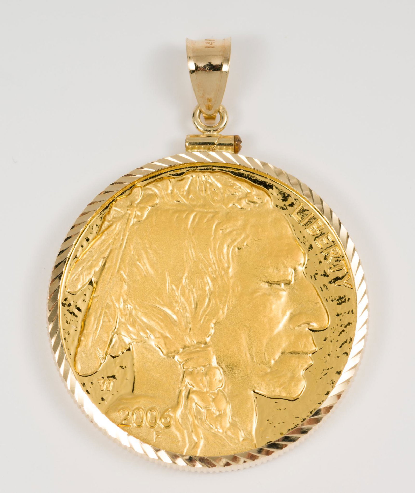 2006 $50.00 Gold Buffalo Coin: 2006 $50.00 Gold buffalo. As pendant. Uncirculated. Coin weight 31.1 g, with total weight 33.6 g including 14k gold bezel. AJ. IMPORTANT: Before bidding, please read the terms and conditions. When you