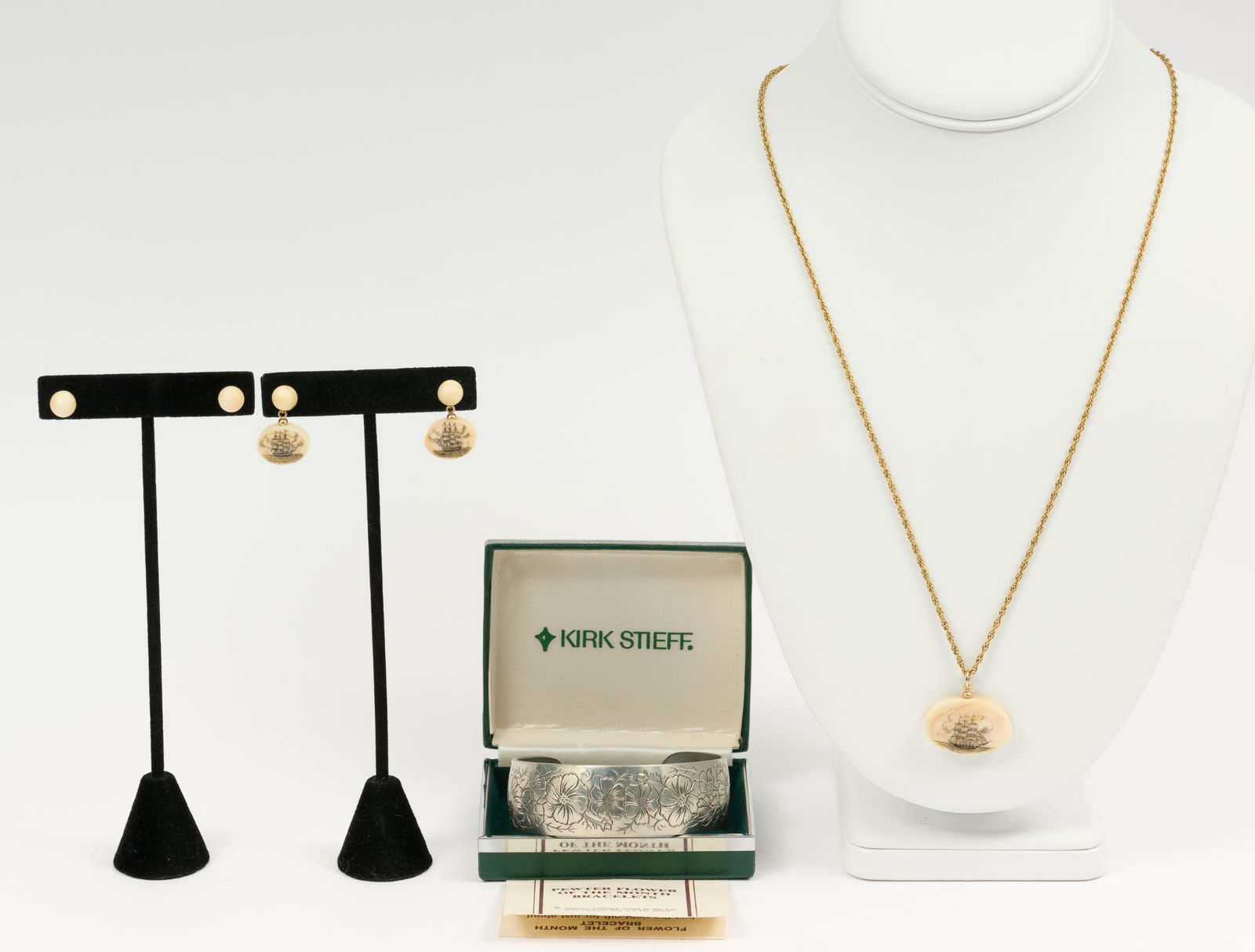 Pewter Cuff and Scrimshaw Jewelry: Kirk Stieff pewter flower of the month bangle (Cosmos - October) engraved To Amy Love Always Dave; in original box, 1" wide. Bone stud earrings. Scrimshaw earrings 1" long with matching pendant neckla