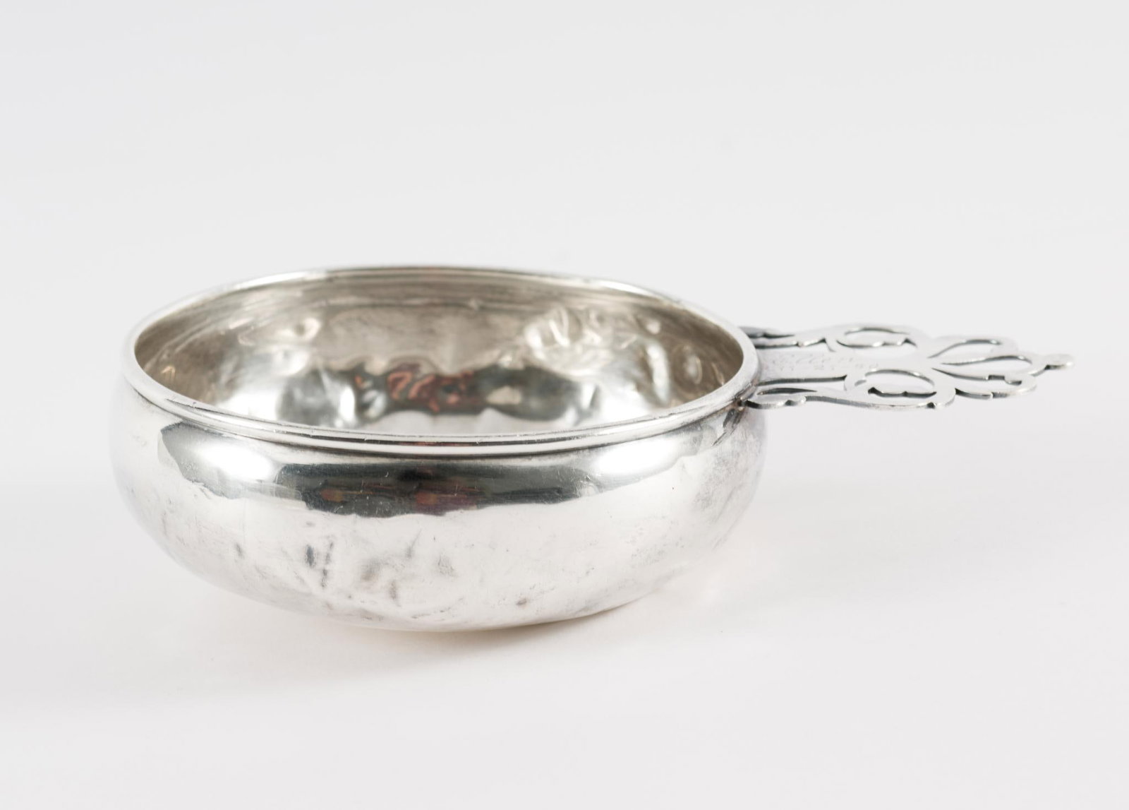 Frank M. Whiting Sterling Silver Porringer: Sterling silver porringer. Marked sterling and Frank M. Whiting on bottom of handle. "Ellen 11-21-50" on top of handle. 4" bowl diameter x 6" long. 2.3 total ozt. Dents and scuffing to piece. AJ.