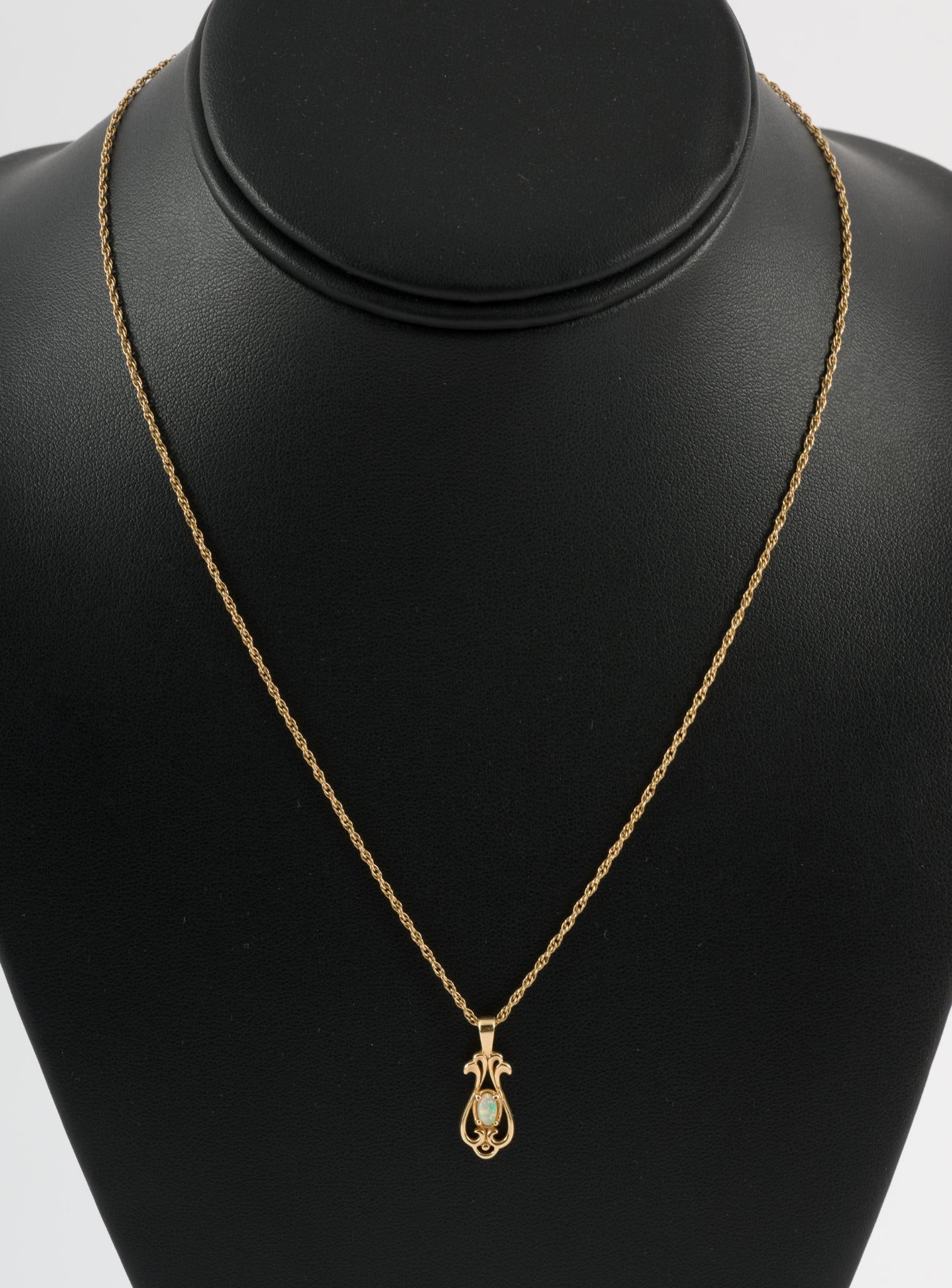 14k Gold Necklace With Pendant: Chain 17" long. Pendant 3/4" long. Pendant marked 14k. 2.1 total dwt/3.3 g. AJ.