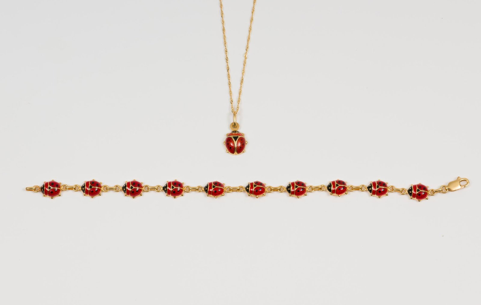 Italian Gold Ladybug Bracelet and Pendant Necklace: Bracelet marked 10K 6" long, 5/8" wide. 5/8" long pendant on 16" chain, both marked 18K. 4.7 dwt/7.3 g. MH.