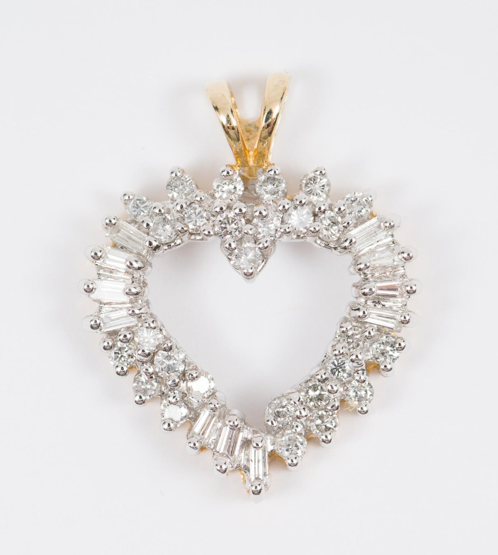 14K Gold & 1.14 CTW Diamond Heart Pendant: Marked 14K. Set with 27 round cut and 11 baguette diamonds,each .03 carat. Total diamond weight approximately 1.14 carats (Clarity Si1, Color G-H). 1" long. 2.0 dwt/3.1 g. MH/EK