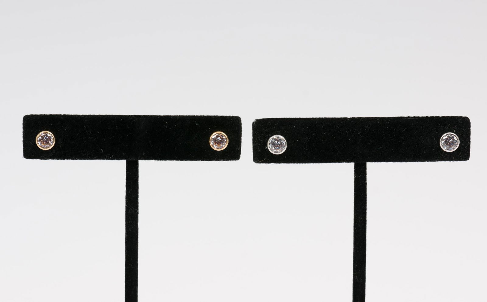 2 Pairs 14k & CZ Stud Earrings: Marked 14K. Yellow and white gold. 1/4" wide. 1.3 dwt / 2 grams. AJ/EK