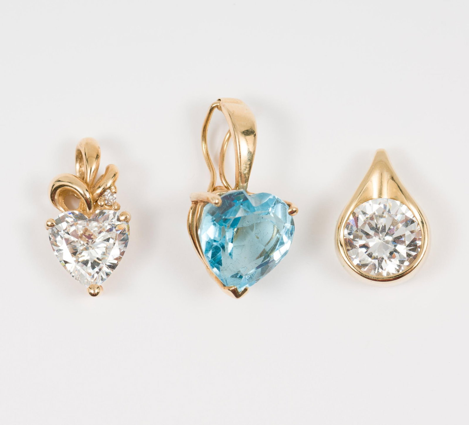 3 14k Gemstone Charms: Marked 14k. One blue topaz and two CZ. 3/8" to 5/8" high. 3.7 total dwt/5.8 g. AJ/EK