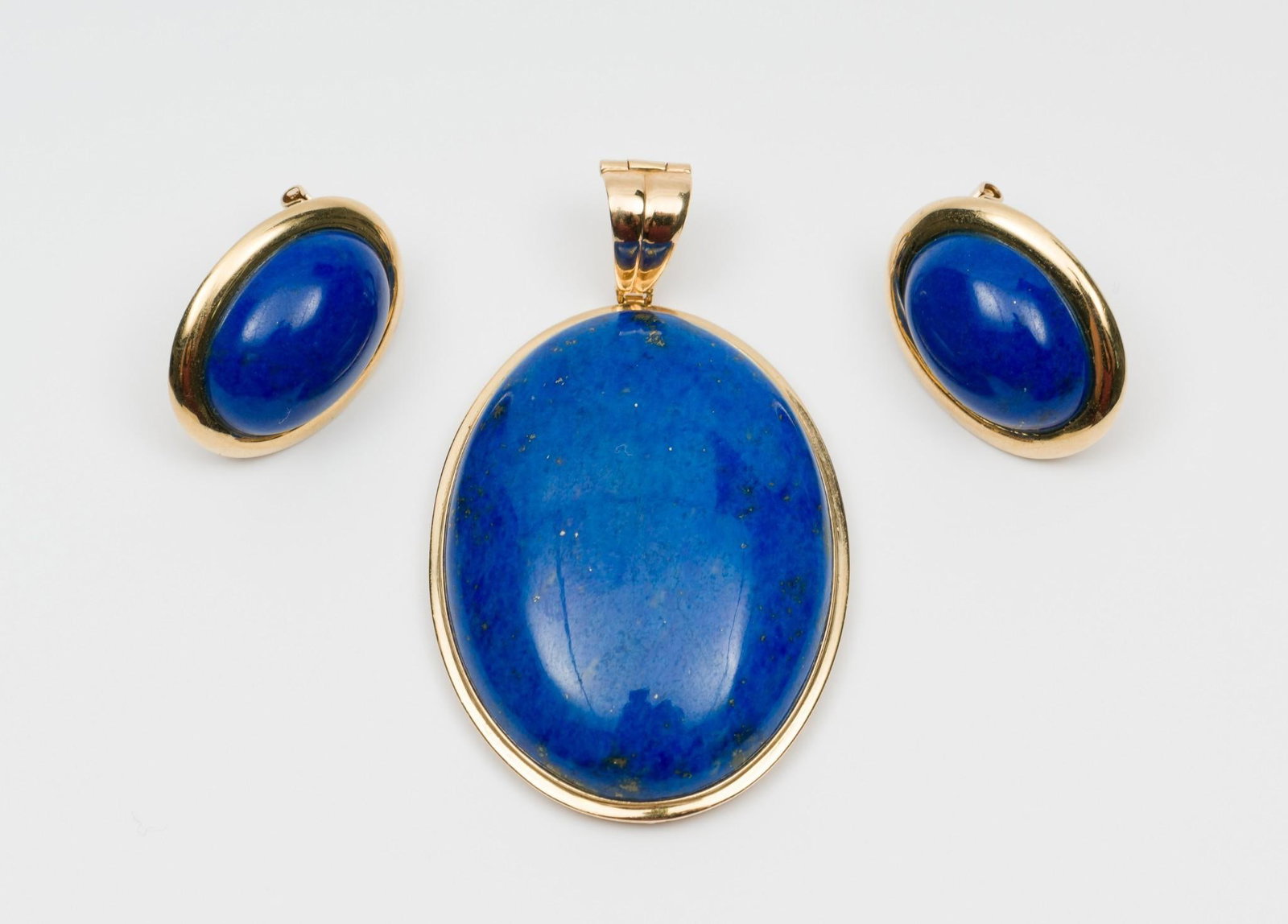 14K Gold and Lapis Enhancer Pendant & Earrings: DESCRIPTION: 14k (stamped 14k 585) gold settings with lapis lazuli cabochons. Enhancer pendant stamped SM for maker. Earrings with pierced omega backs. MEASUREMENTS: Pendant 1-3/4" x 1-1/8". Earrings 