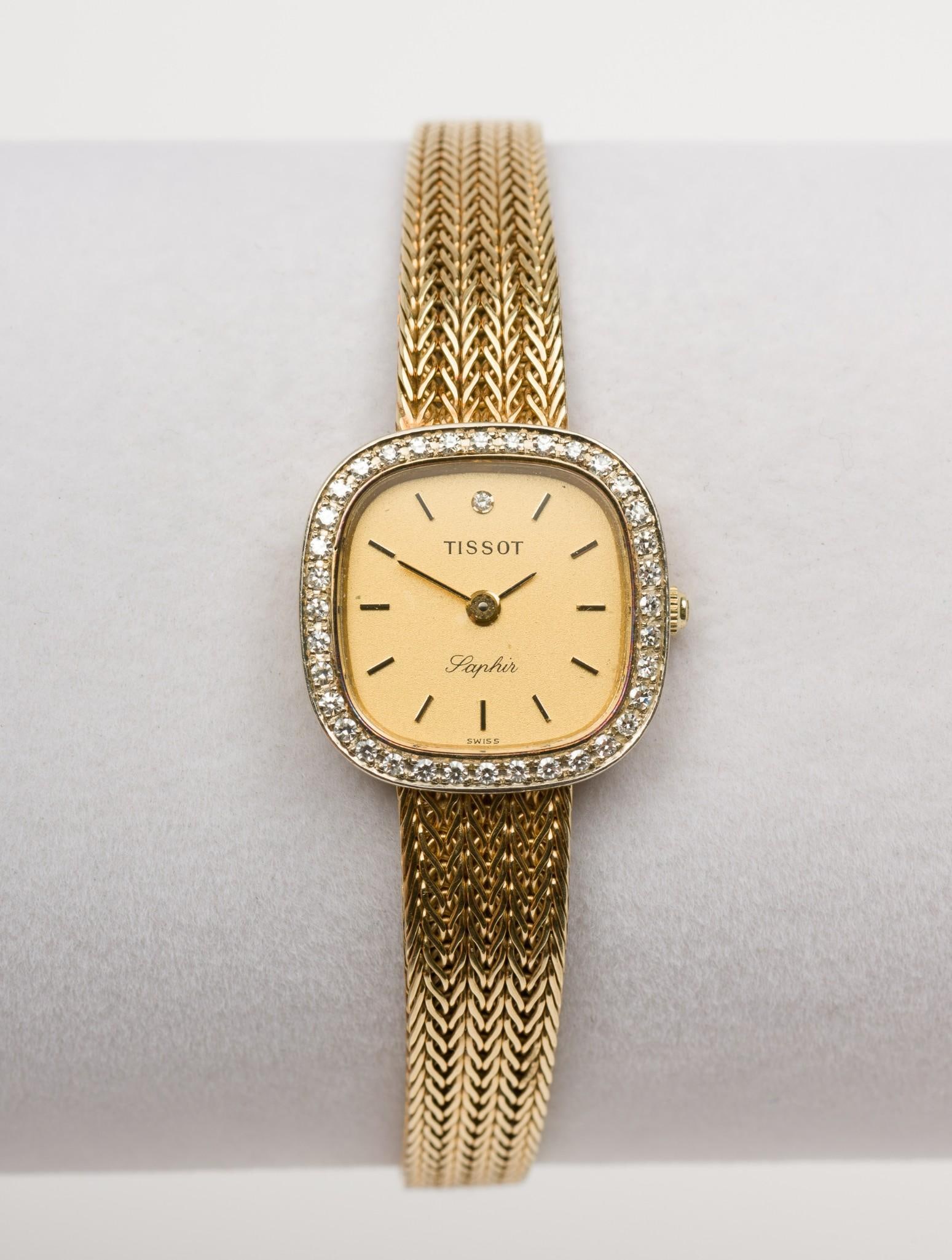 14k Gold Tissot Laphir Ladies Wristwatch: DESCRIPTION: Tissot quarts 14k dress watch. With diamond bezel. Marked 585 Swiss Made 14k. Gold band with square watch face. MEASUREMENT: 3/4" wide x 7-1/4" long. 23 grams. Watch 21.2 g with the movem