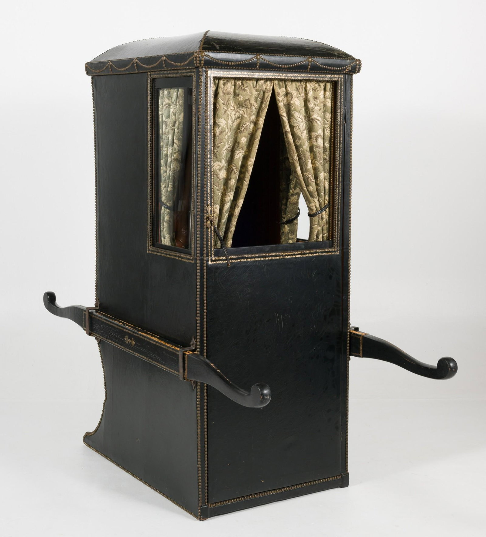 Sedan Chair: DESCRIPTION: Early 20th century wood and leather sedan chair probably European, possibly English. The form consisting of an upright windowed seating box with a bench and curtains. The outside with two