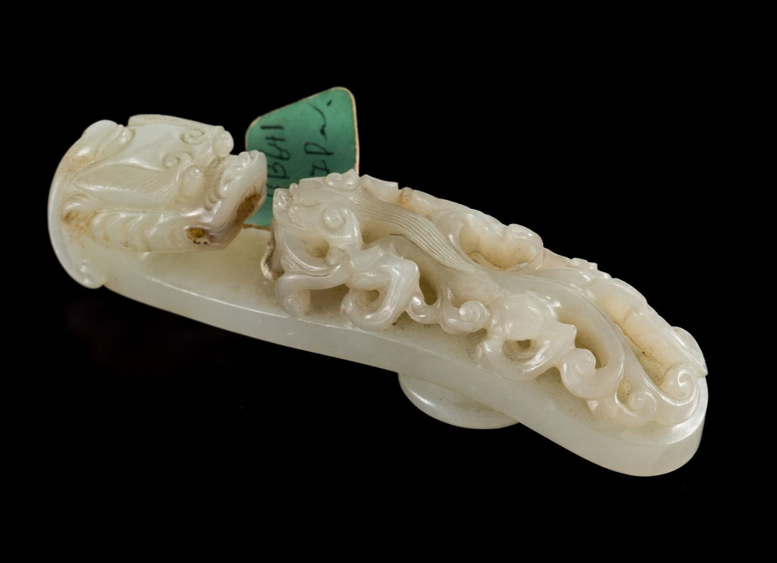 Qing Dynasty (1636-1912) Celadon Jade Carved Belt Hook: DESCRIPTION: Celadon jade carved belt with carved dragon hook and carved dragon on base. Qing dynasty was a Manchu-led imperial dynasty and was the last imperial dynasty of China. PROVENANCE: George H