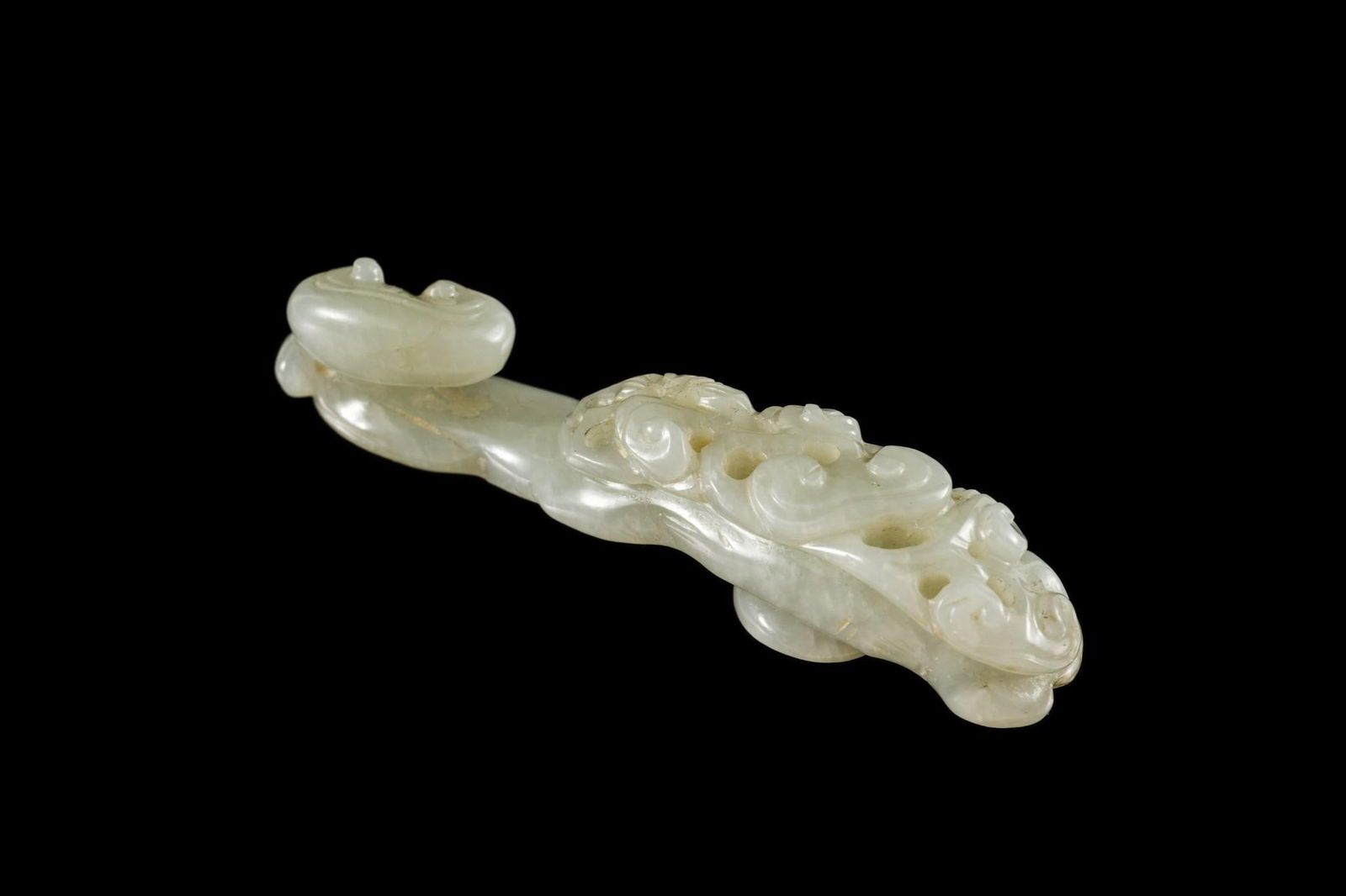 Qing Dynasty (1636-1912) Celadon Jade Belt Hook Lingzhi Mushroom Designs: DESCRIPTION: Celadon jade carved belt hook with lingzhi. Qing dynasty was a Manchu-led dynasty and was the last imperial dynasty of China. PROVENANCE: George Henne November 1866 - June 2, 1938. By inh