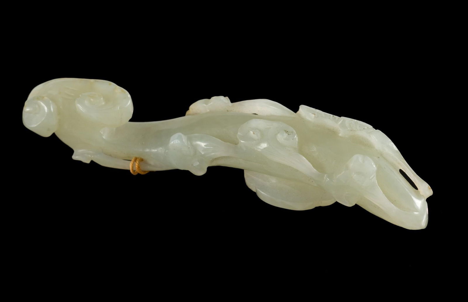 Qing Dynasty (1636-1912) Celadon Jade Belt Hook Double Curved: DESCRIPTION: Celadon jade carved belt hook with lingzhi. Qing dynasty was a Manchu-led dynasty and was the last imperial dynasty in China. PROVENANCE: George Henne November 1866 - June 2, 1938. By inh