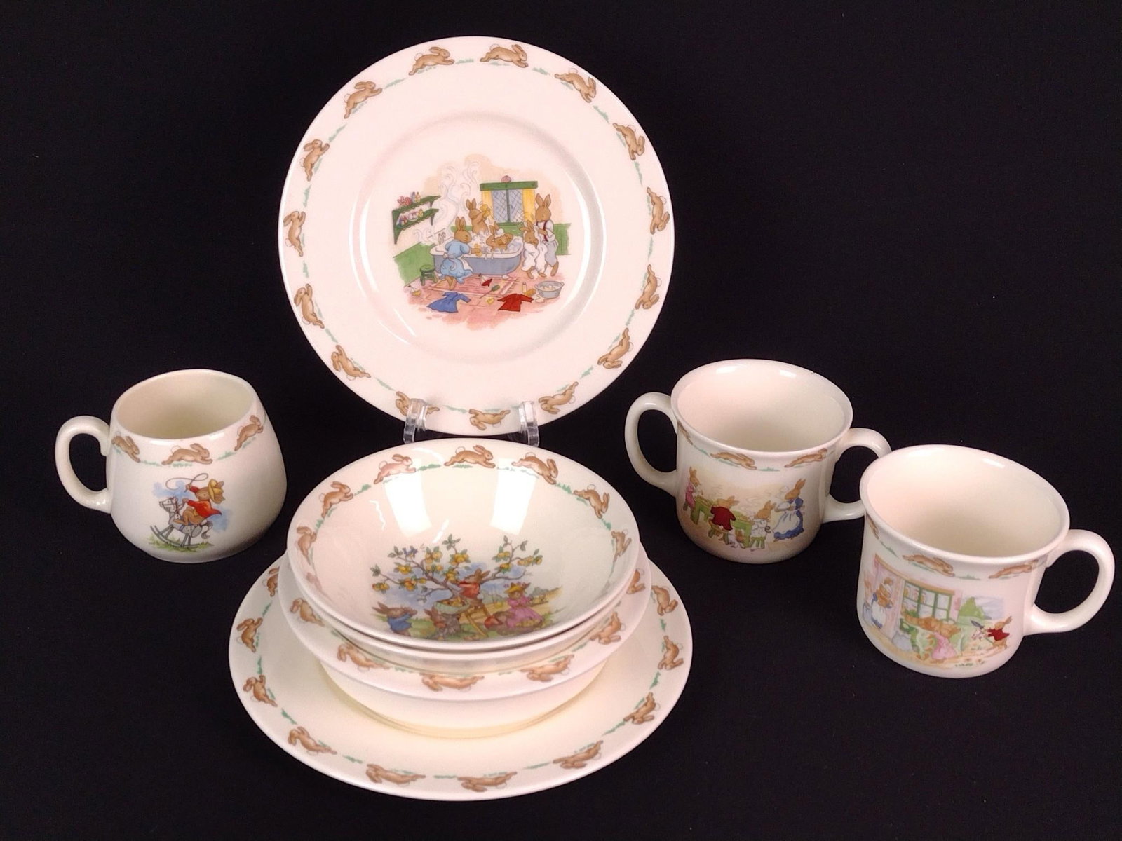 8 Pcs Royal Doulton Bunnykins Childs Dinnerware: Cups 3" high. Plates 8" diameter. MG.