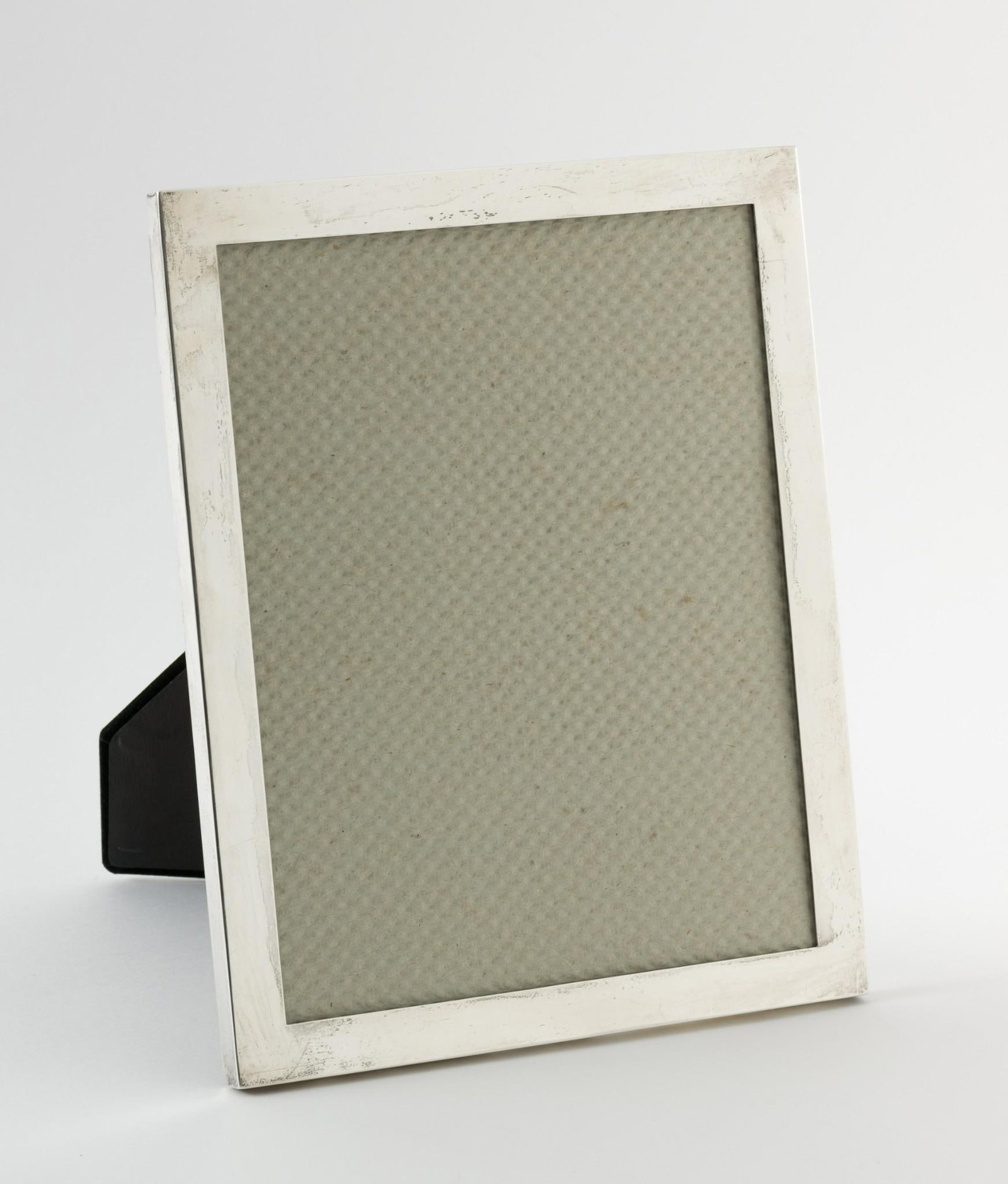 Sterling Picture Frame: Sterling picture frame. Marked sterling. Sterling weight 3.40 ozt. 8-1/4" wide x 10-1/4" high. Light scratching consistent with use. MEG