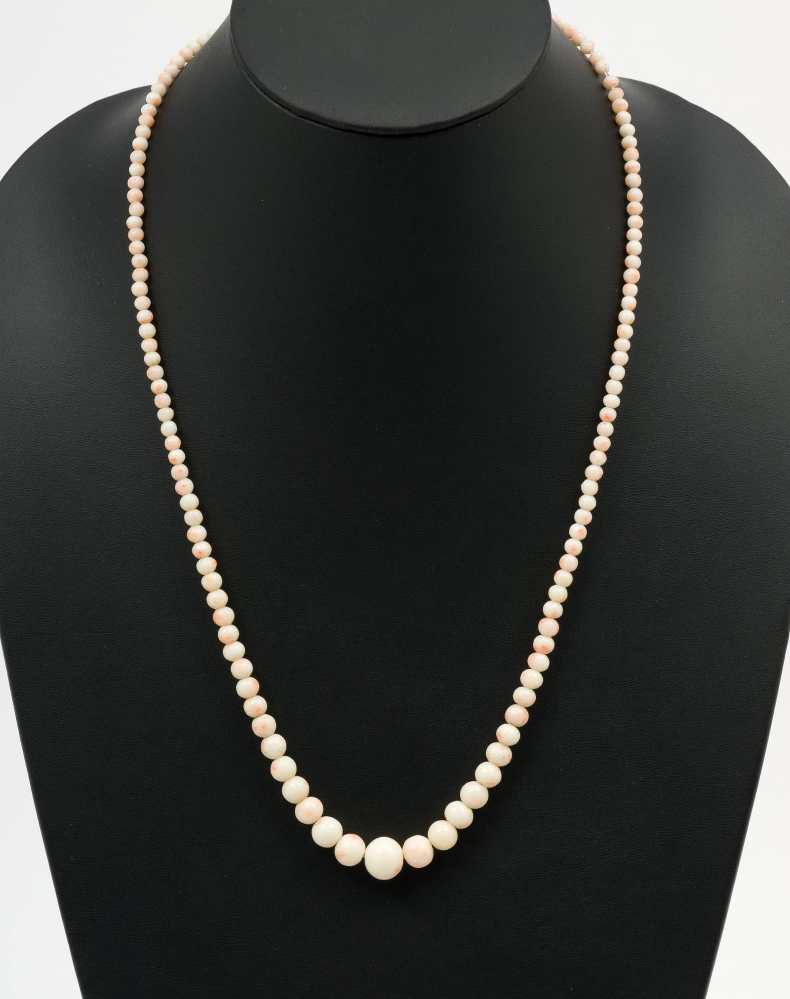 Angel Skin Coral Bead Necklace: Necklace with graduated angel skin coral beads. 24" long. Beads 1/8" to 3/8" wide. AJ.