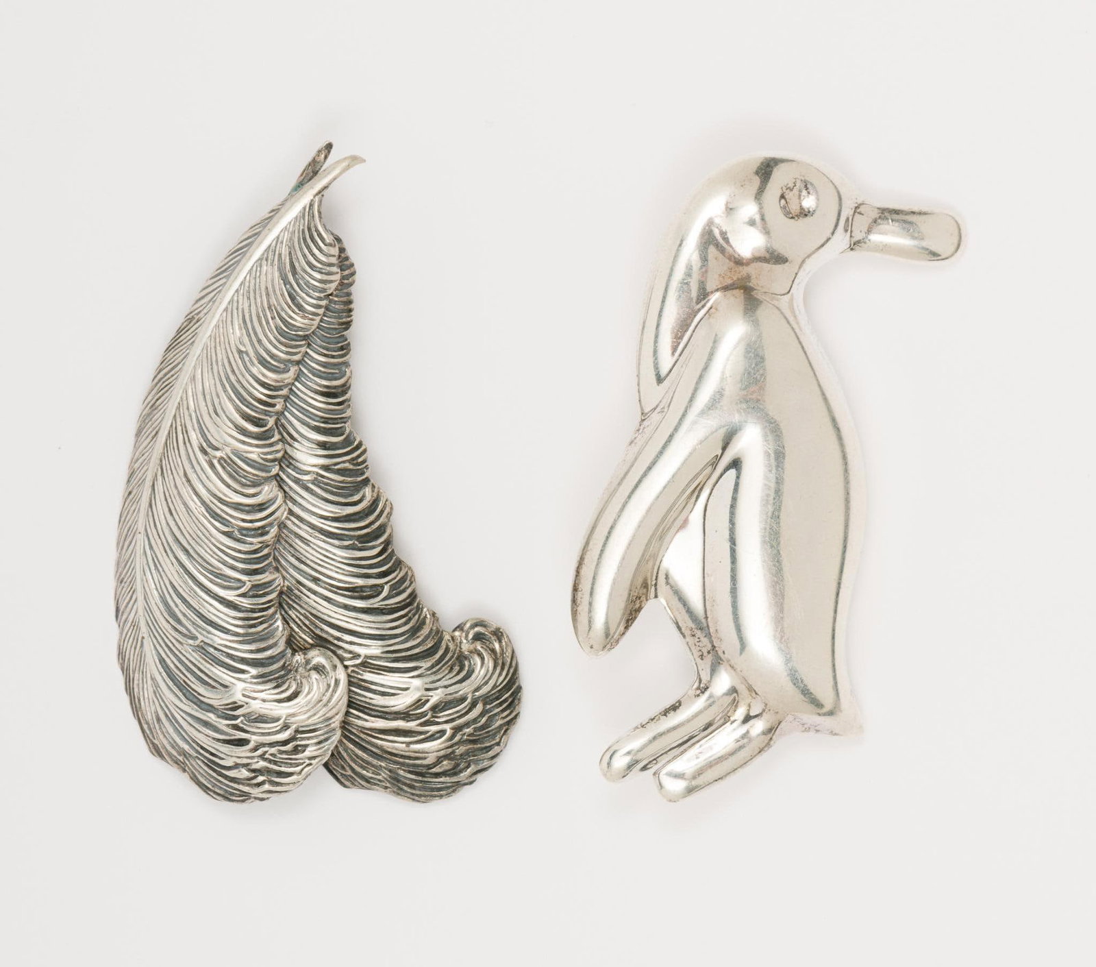 2 Sterling Brooches Incl. Penguin: Includes Penguin and feathers. 1-3/4" and 2" high. 0.6 total ozt. AJ.