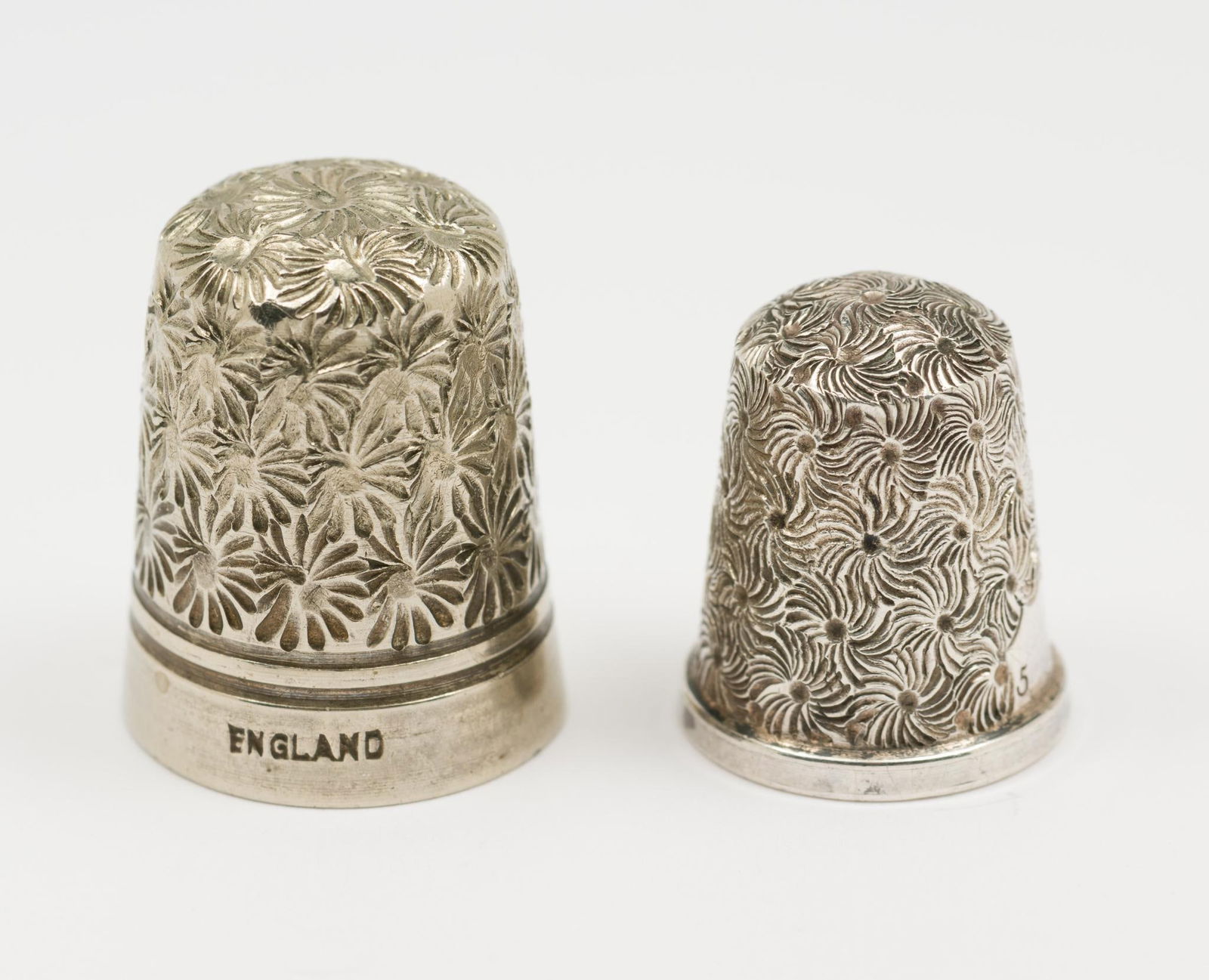 2 Sterling Thimbles: One marked England. Light wear as expected with age and use. 0.3 total ozt. AJ.