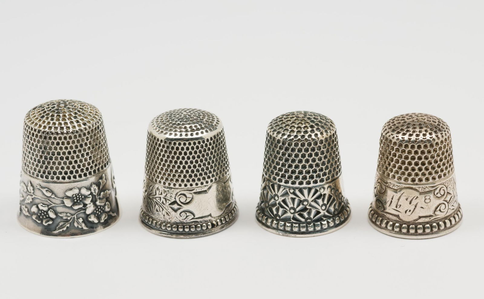 4 Ketcham McDougall Sterling Thimbles: 4 sterling thimbles. All marked Ketcham McDougall to inside. Floral patterns around bands. 0.6 total ozt.. AJ.
