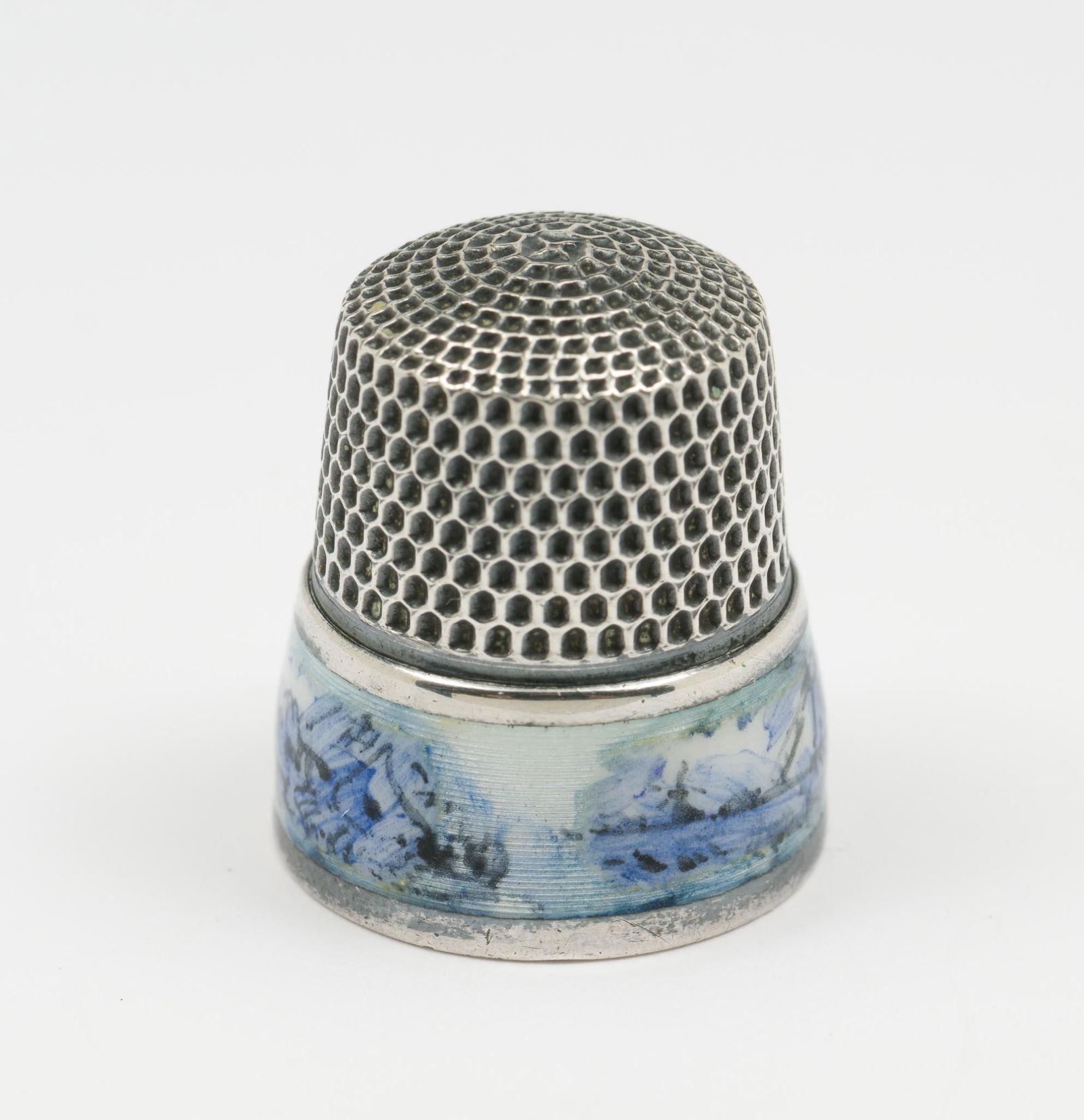 Antique Sterling Thimble With Delft Enamel Band: Antique thimble with delft enamel band of country scenery. Marked sterling to inside. 0.2 total ozt. AJ.
