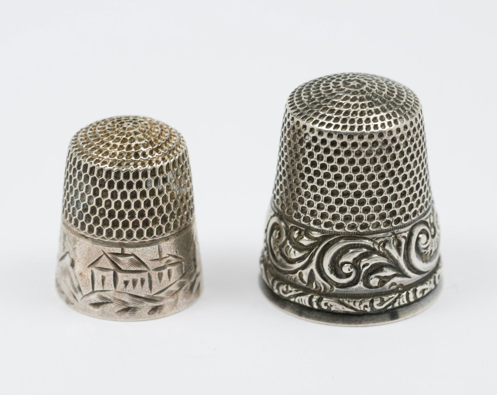 2 Stern Bros. Sterling Thimbles With Decorative Edges: 2 Stern Bros. sterling thimbles. Both with decorative bases. Light wear as expected with age and use. 0.3 total ozt. AJ.