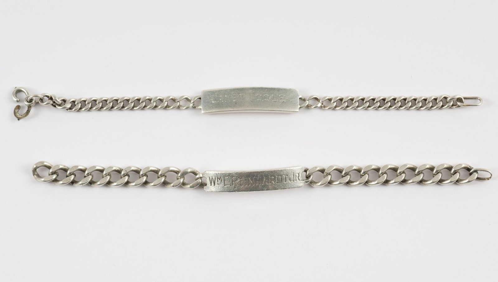 2 Sterling ID Bracelets: 2 sterling ID bracelets. First engraved Janet Poole, second engraved William E. Reinhardt, Jr. Both marked sterling. 1/2" wide x 7" to 8" long. 2.07 ozt total. Scratching consistent with age and use. 