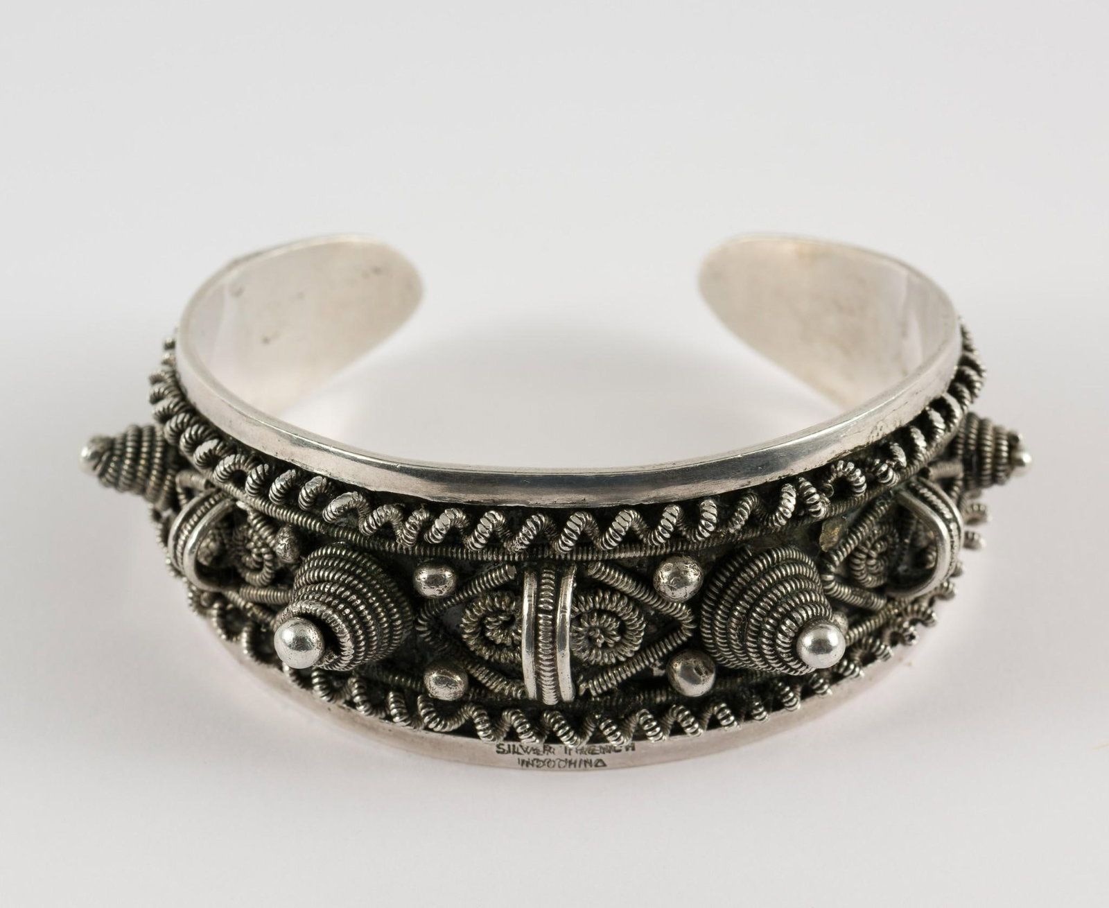 Sterling Cuff: Sterling cuff. Marked Silver French Indonesia. 1" wide x 2-1/4" diameter. 1.34 ozt total. Scratching consistent with age and use. MEG