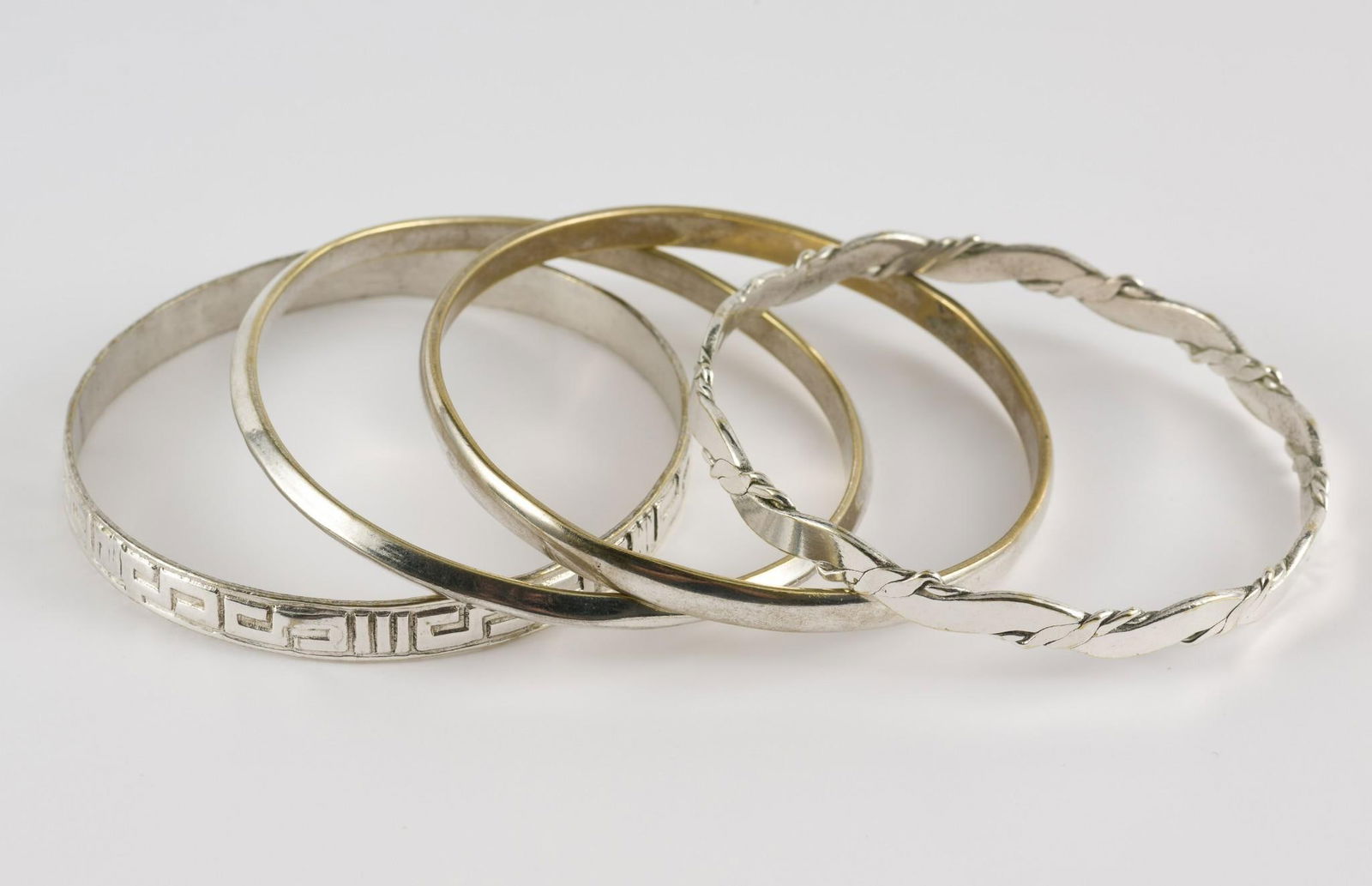 4 Sterling Bangles: Four sterling bangles. All marked. 1/4" to 3/8" wide x 2-3/4" diameter. 2.07 ozt total. No condition issues. MEG