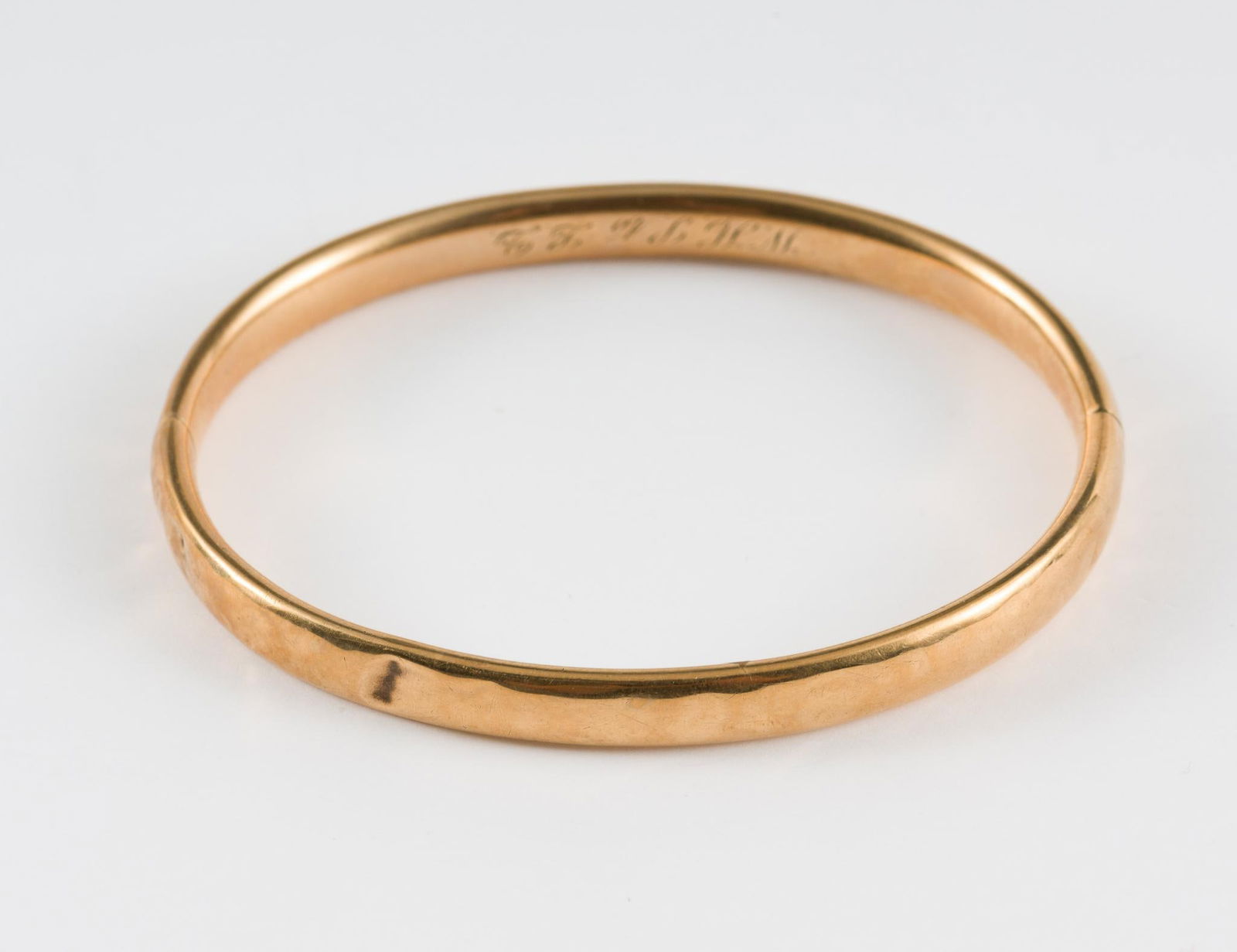 14K Gold Bangle Bracelet: Tests 14k. Engraved on inside. 10 grams. 1/4" wide x 2-1/2" diameter. Light scratching and small dent consistent with age and use. MEG