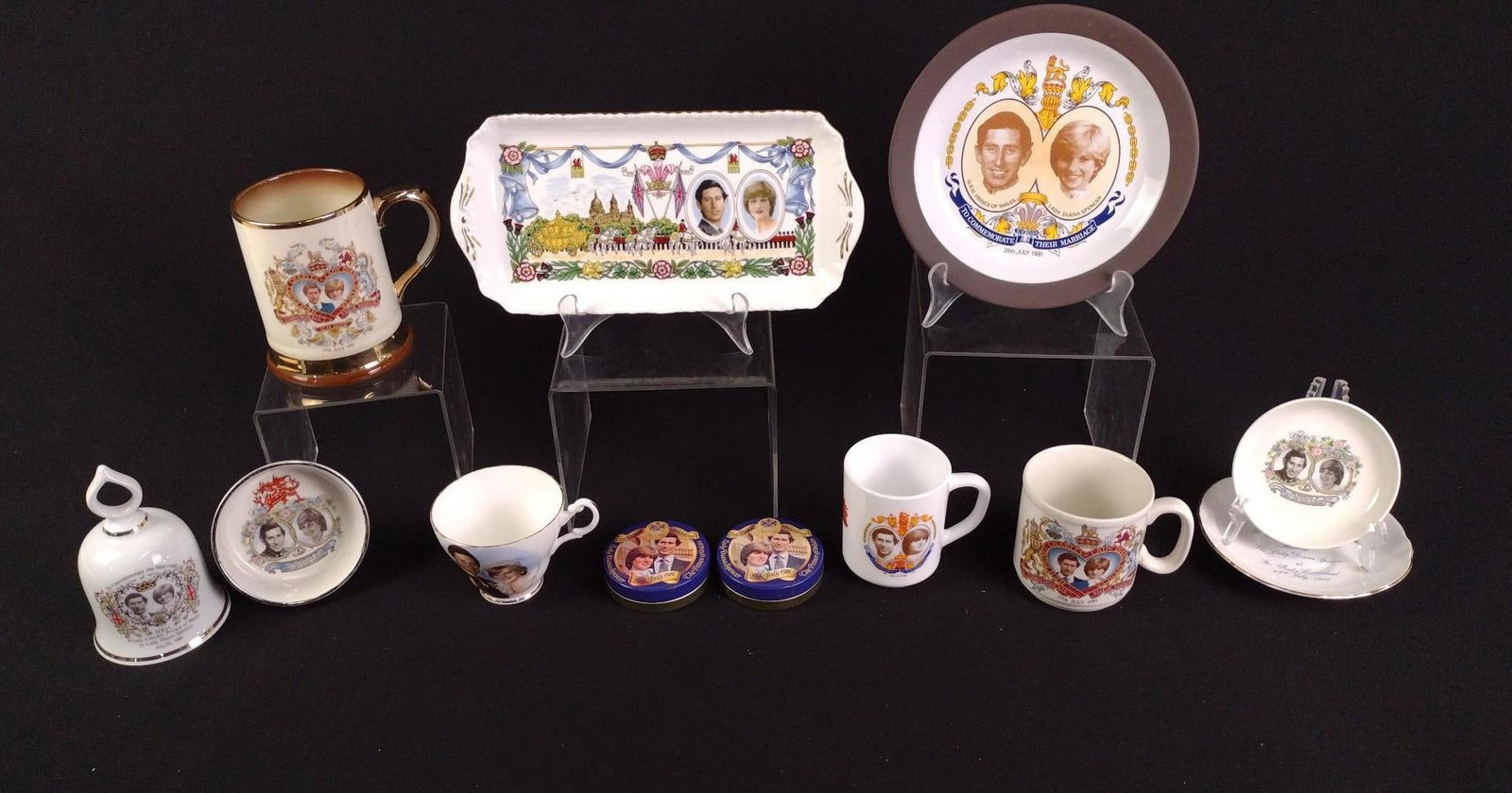 12 Royal Commemoratives incl Prince Charles and Lady Diana Tray: Tray: 11-1/4" long. 1" to 5-1/2" high. LR