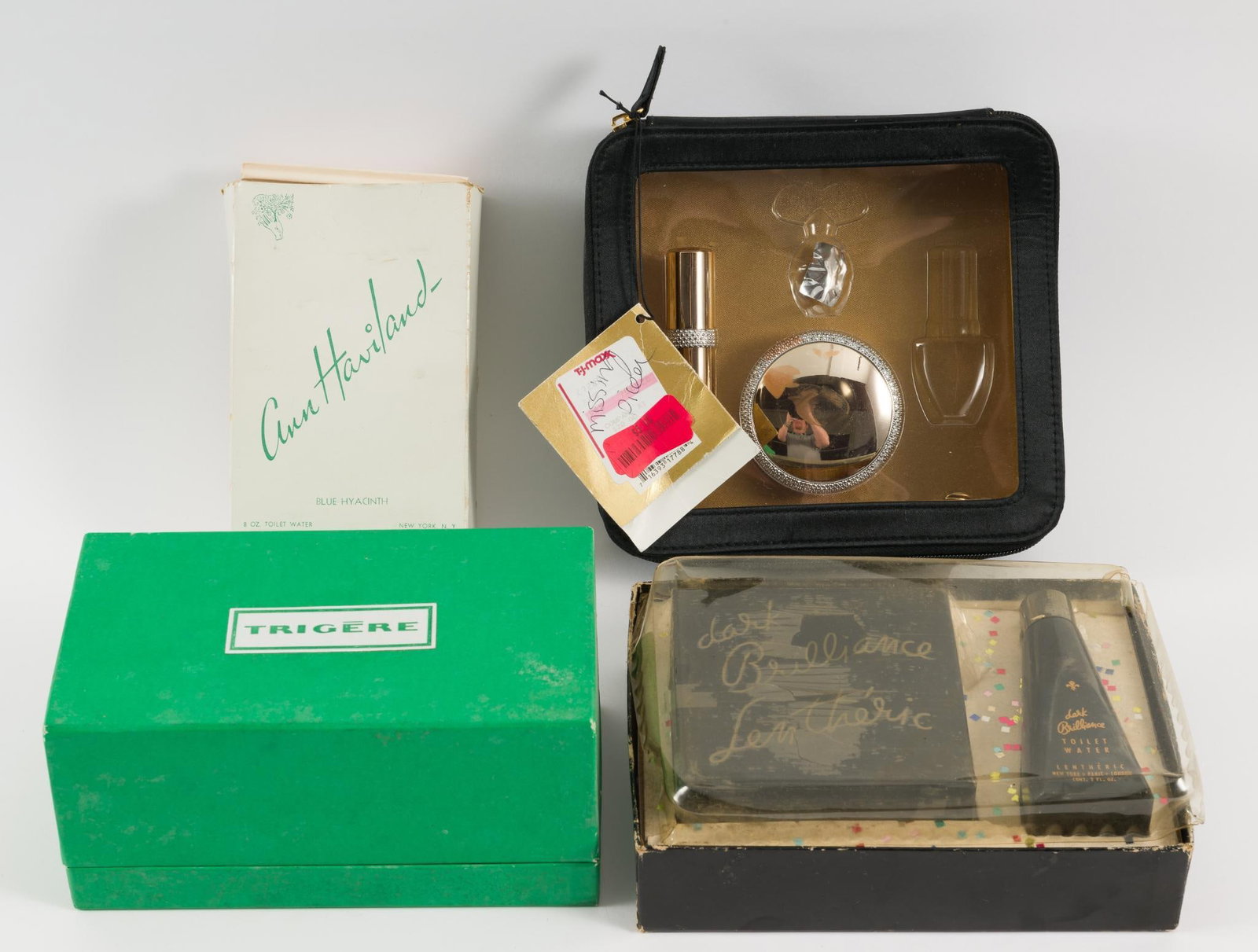 4 Boxes of Perfume: Includes: Trigere, Elizabeth Taylor, Ann Haviland, and Dana Brillance Lentheric. 4" to 7-3/4" wide x 3-3/4" to 5-3/4" high. JS