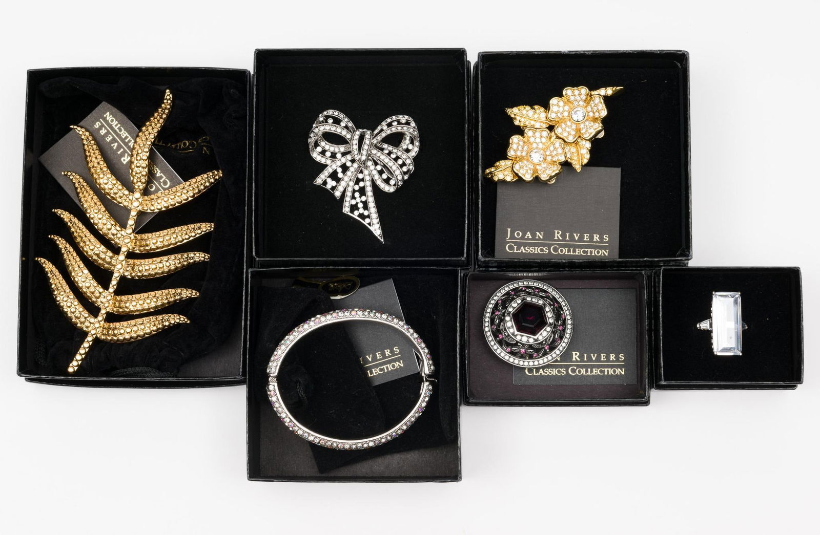 6 Pieces Joan Rivers Jewelry: Ring size 8. Bracelet 2" by 2-1/2" interior. Pins 1-1/2" to 5-1/2" high. JS