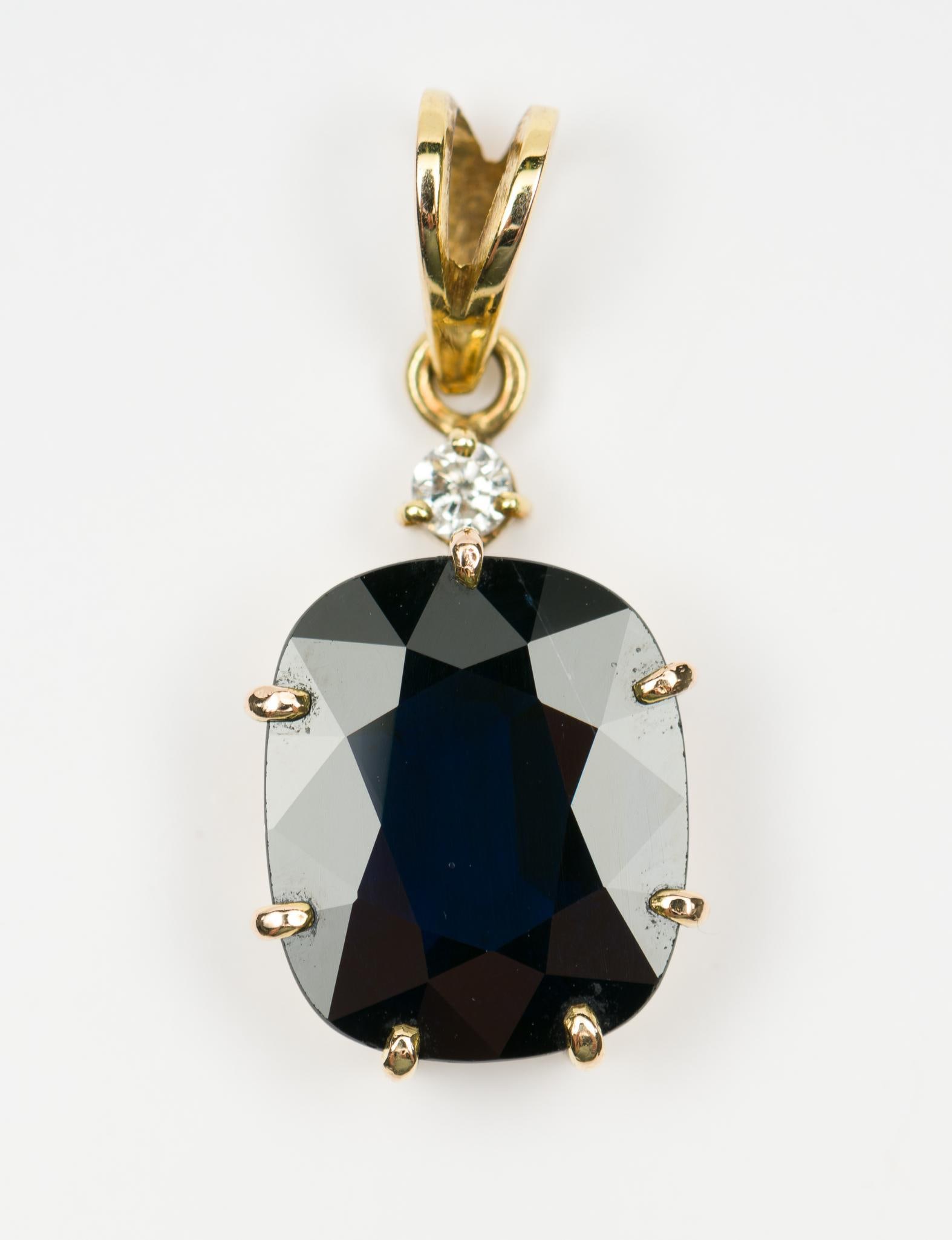 14K Gold, Sapphire & Diamond Pendant: Marked 14k pendant set with rectangular cushion cut blue sapphire and .05 carat round cut diamond. 1" high. 2.6 grams. EK
