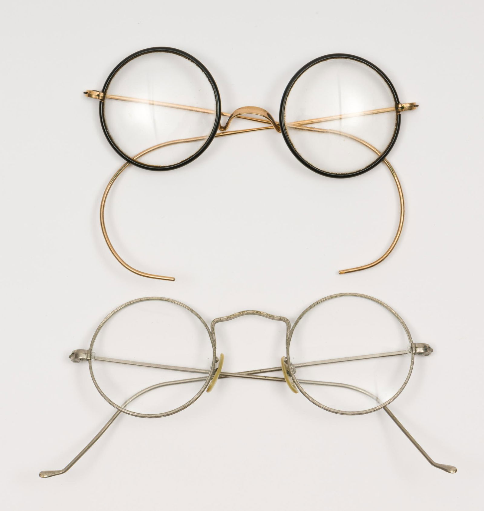 2 Prs Antique Eyeglasses: Includes ARISHL and silver frame. Frames test 14K. 4" to 4-1/2" wide. JS