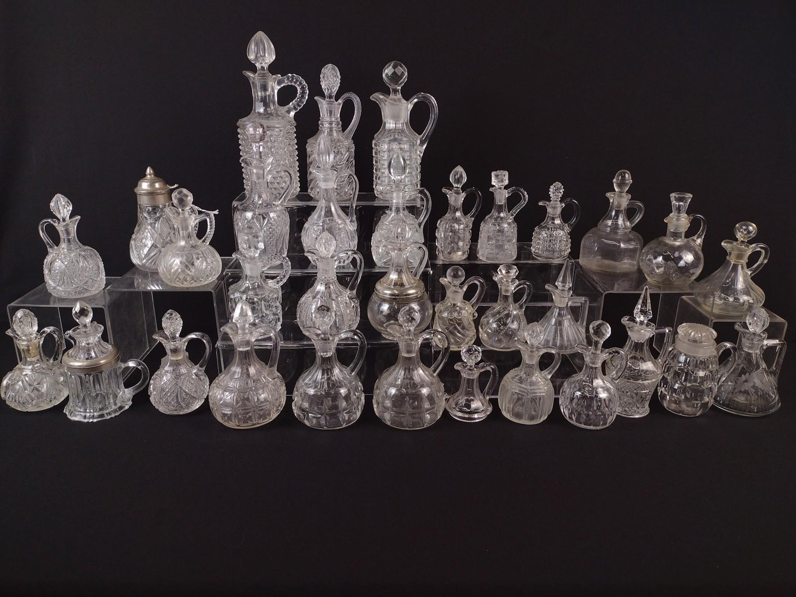 33 Glass Cruets: 4-1/2" to 9-3/4" high. Some losses to stoppers. LR