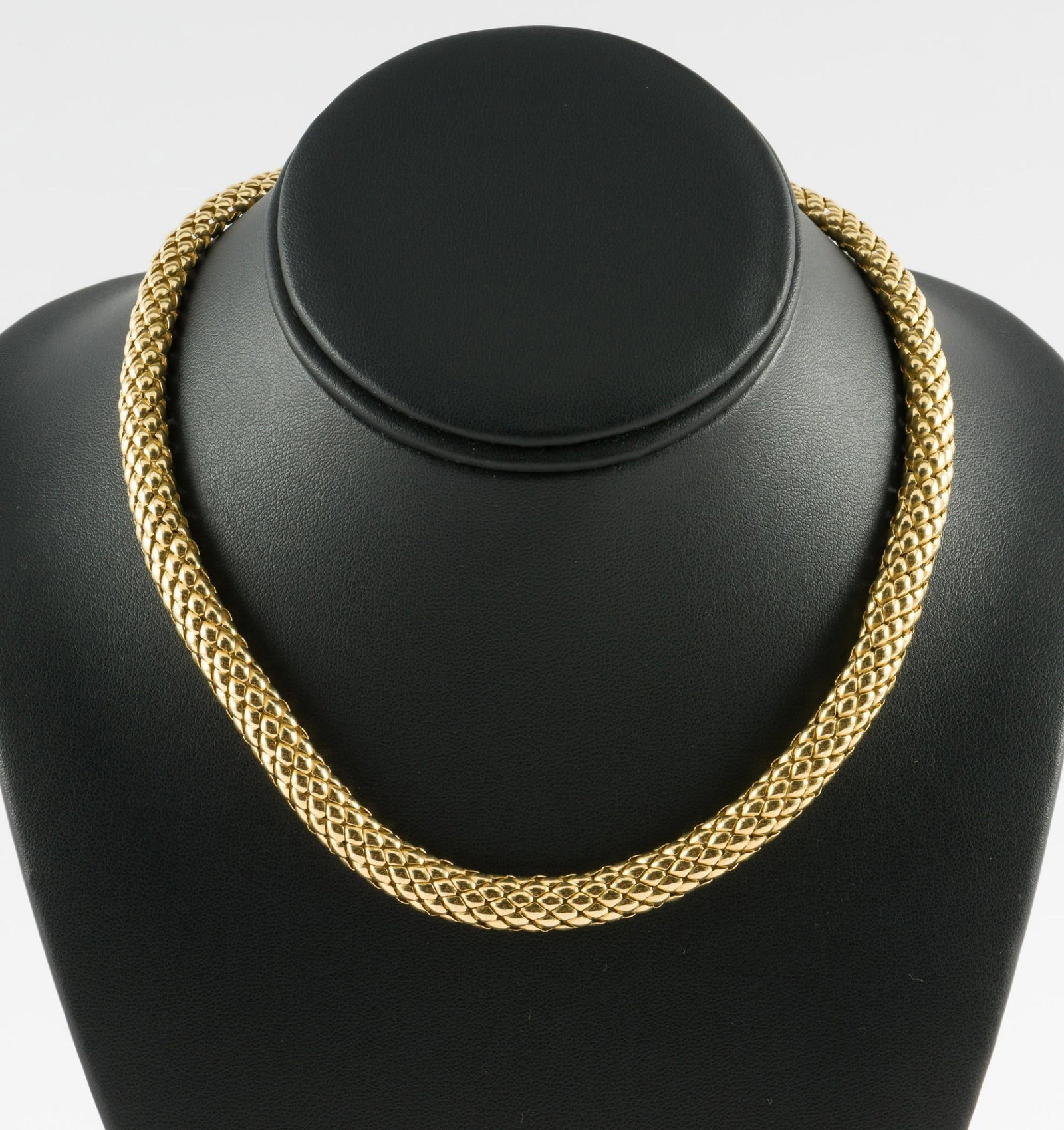 Italian 14k Gold Necklace: DESCRIPTION: Marked k14 Italy gold choker with serpent scale pattern links. MEASUREMENTS: 17-1/4" length. 5/16" wide. 32.6 grams.